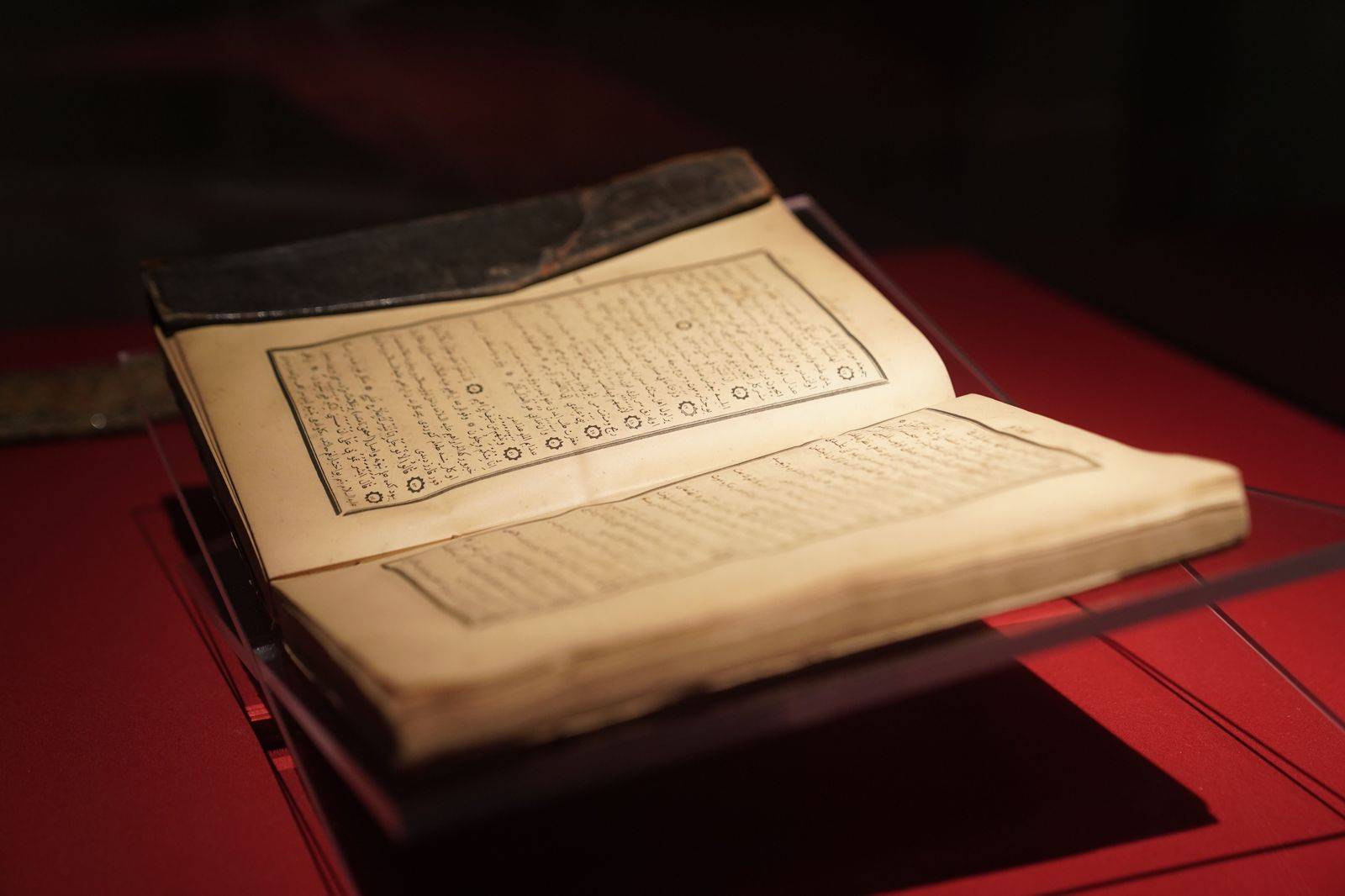 Illuminated manuscripts and ceramics in a museum display case
