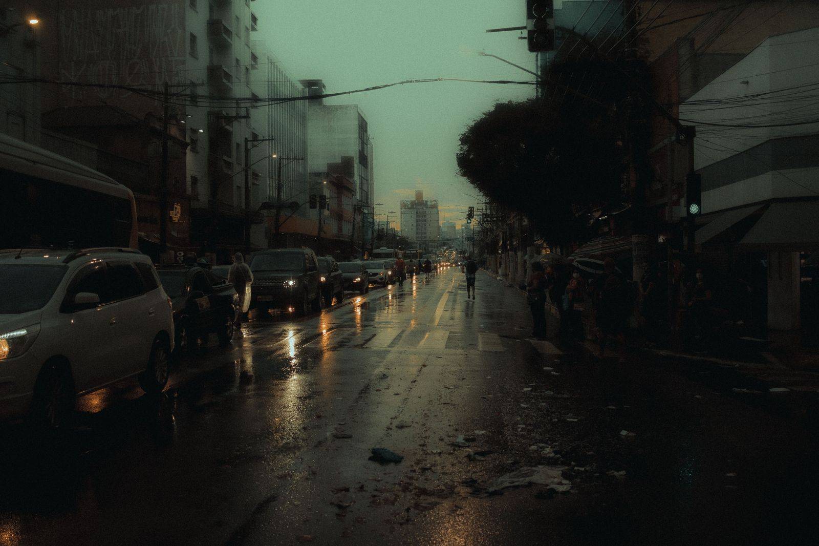 A black car on a downtown Toronto street in the evening