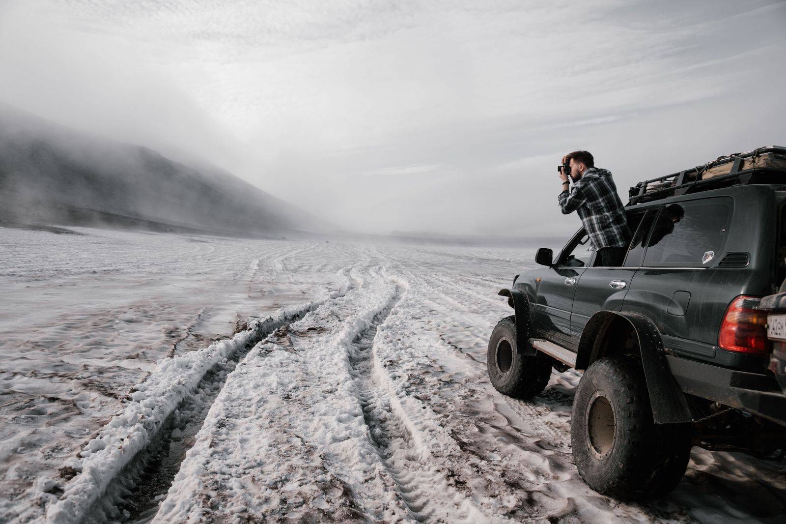 A black SUV driving on a snowy Ontario road in winter