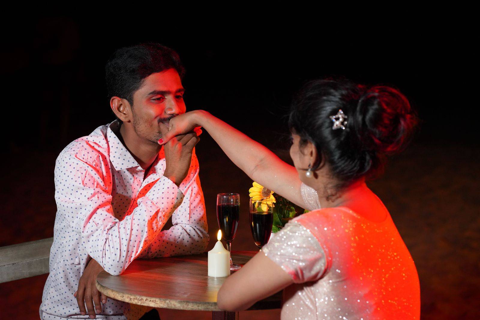 A couple at a candlelit dinner table in a restaurant