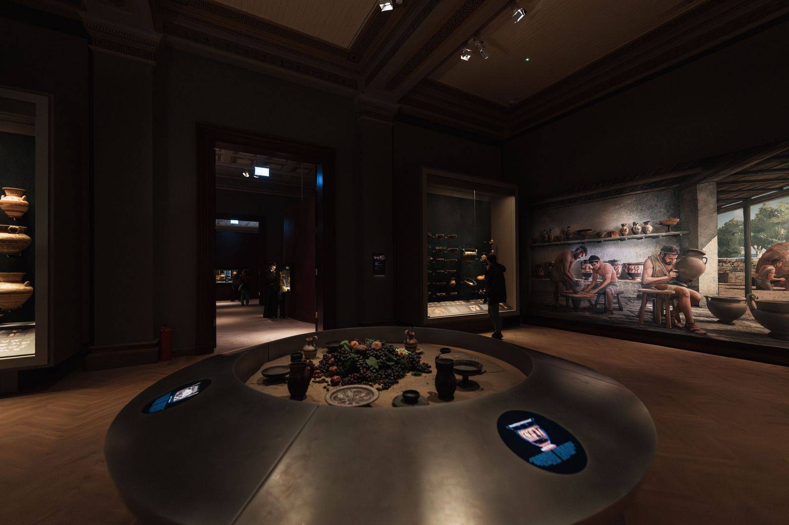 Visitors looking at a ceramics display in a Toronto museum gallery