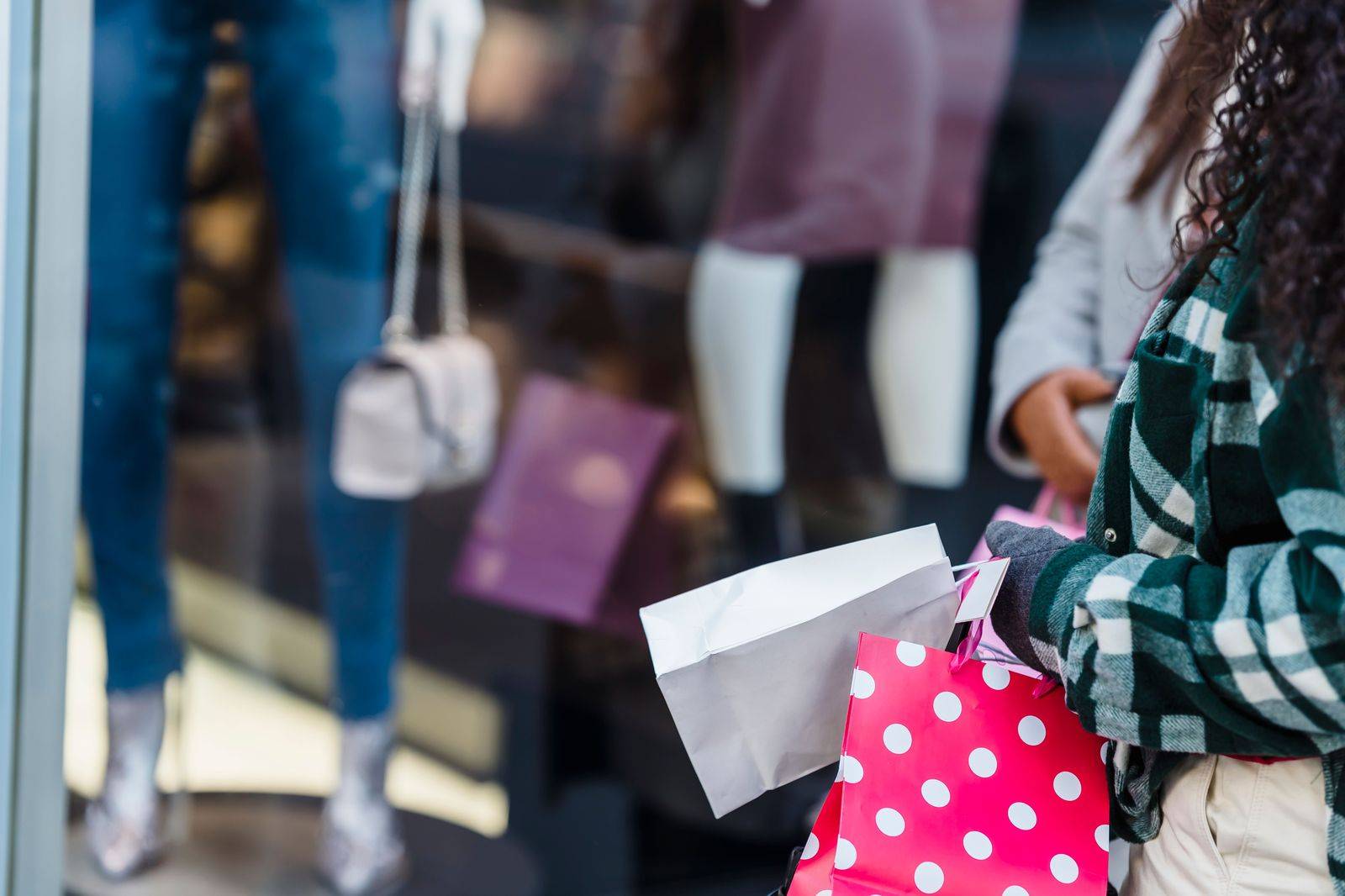 A shopper leaving a boutique with bags, the moment a chauffeur takes over at the Yorkdale curb