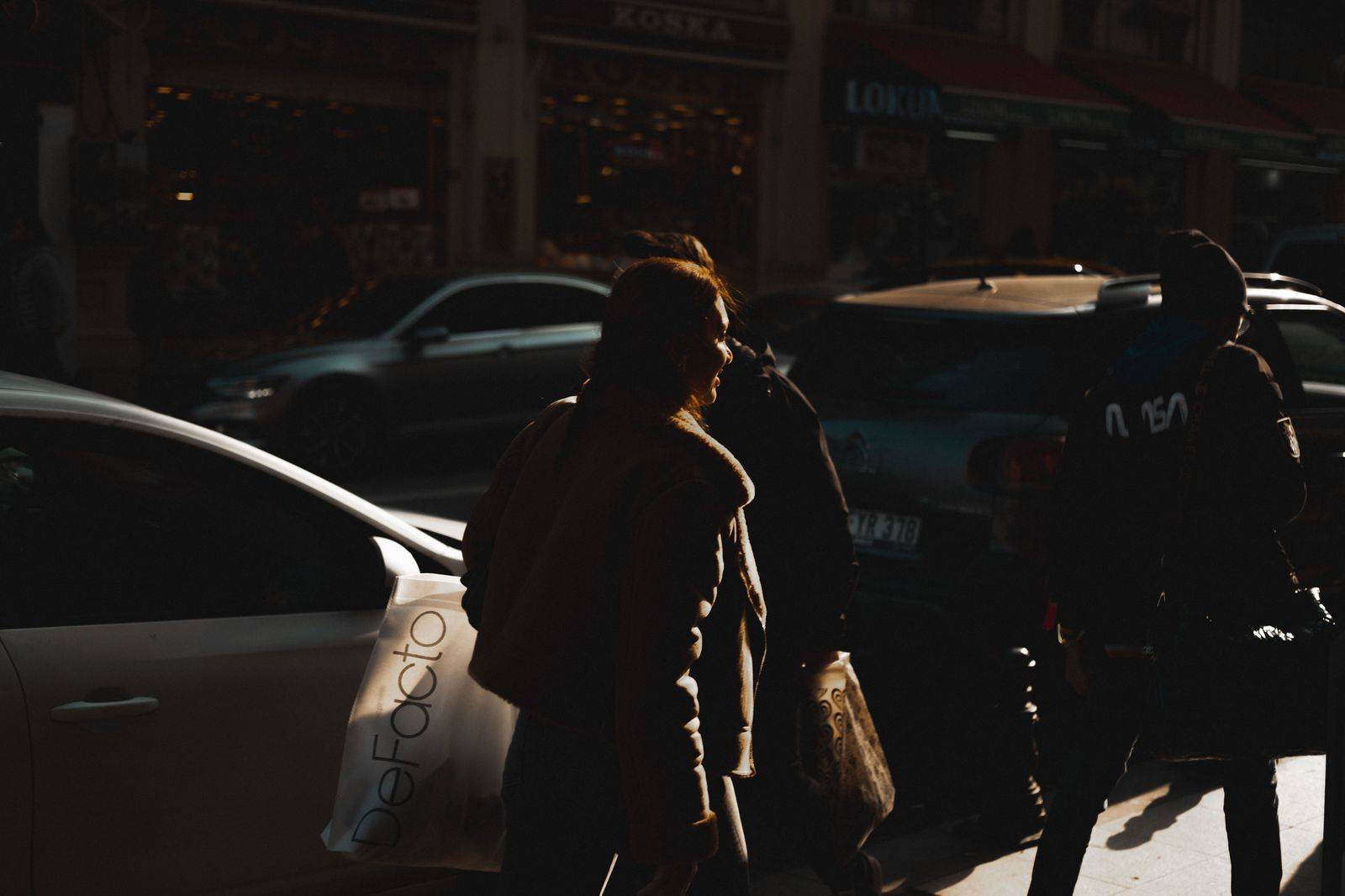 A shopper with bags beside a waiting black car on a Yorkville street, the easy way to handle a long afternoon on Bloor