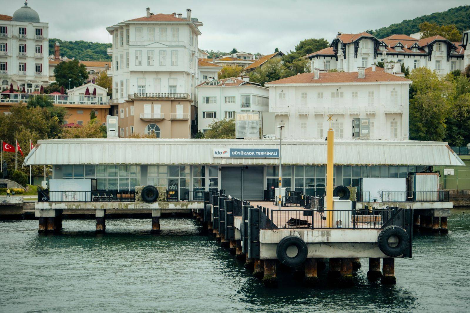 A small waterfront airport terminal with a ferry dock
