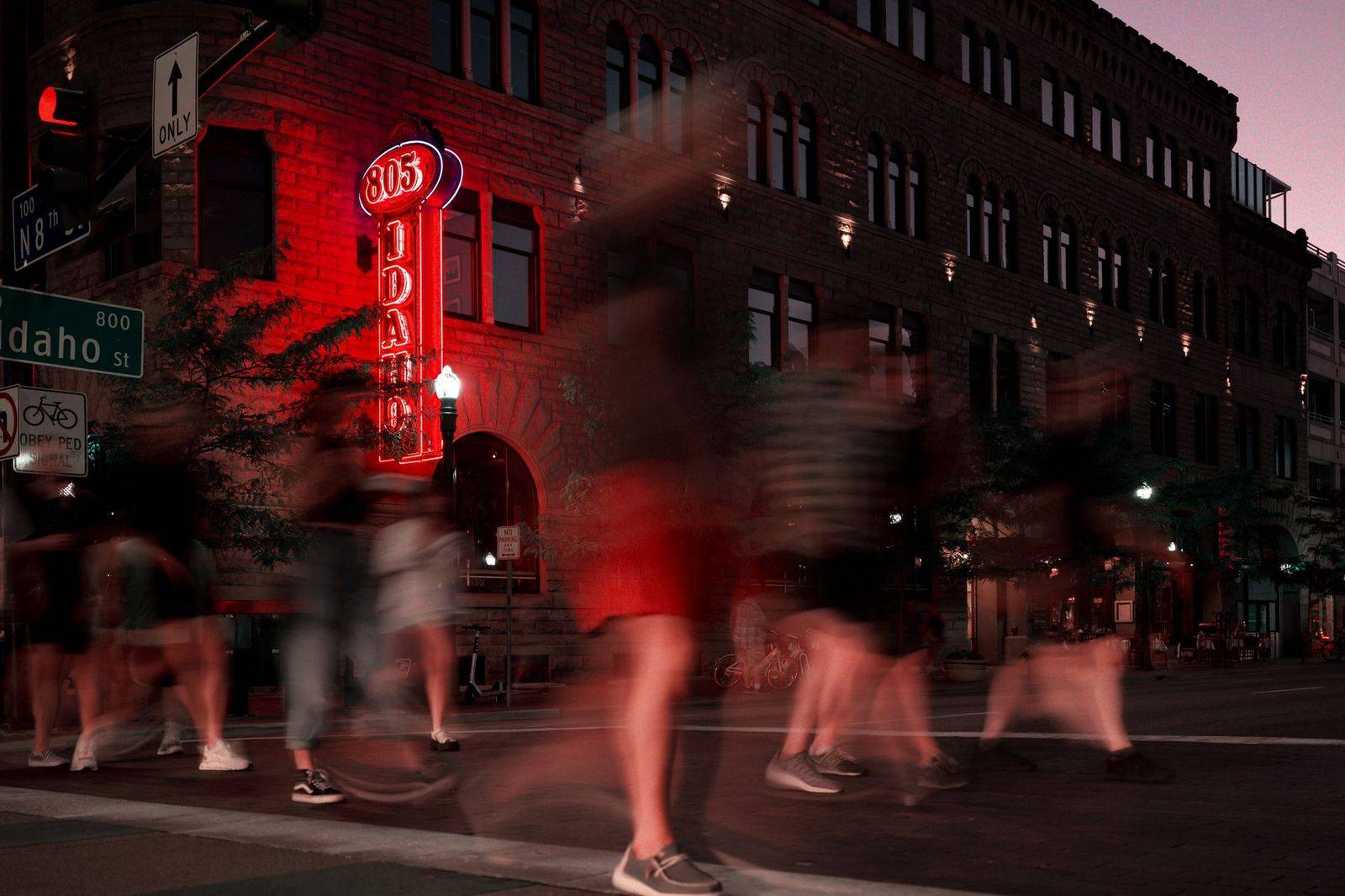Concert-goers walking along a downtown street after a show at night