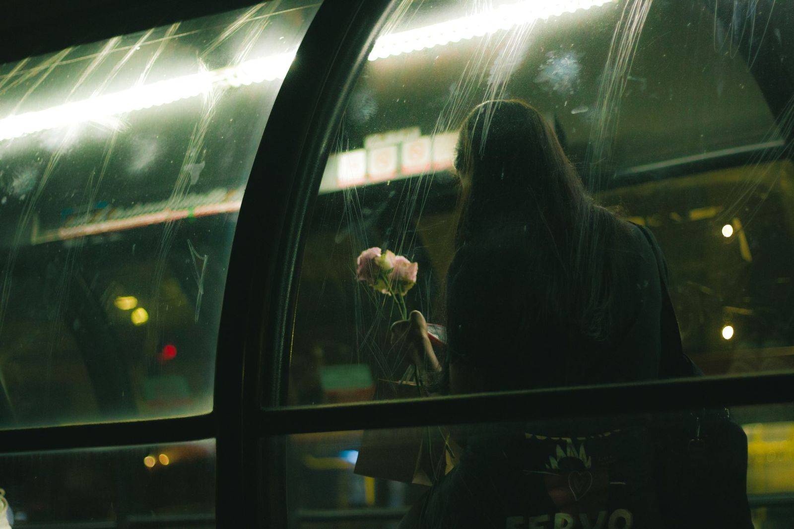 Friends celebrating together inside a bus with coloured lights