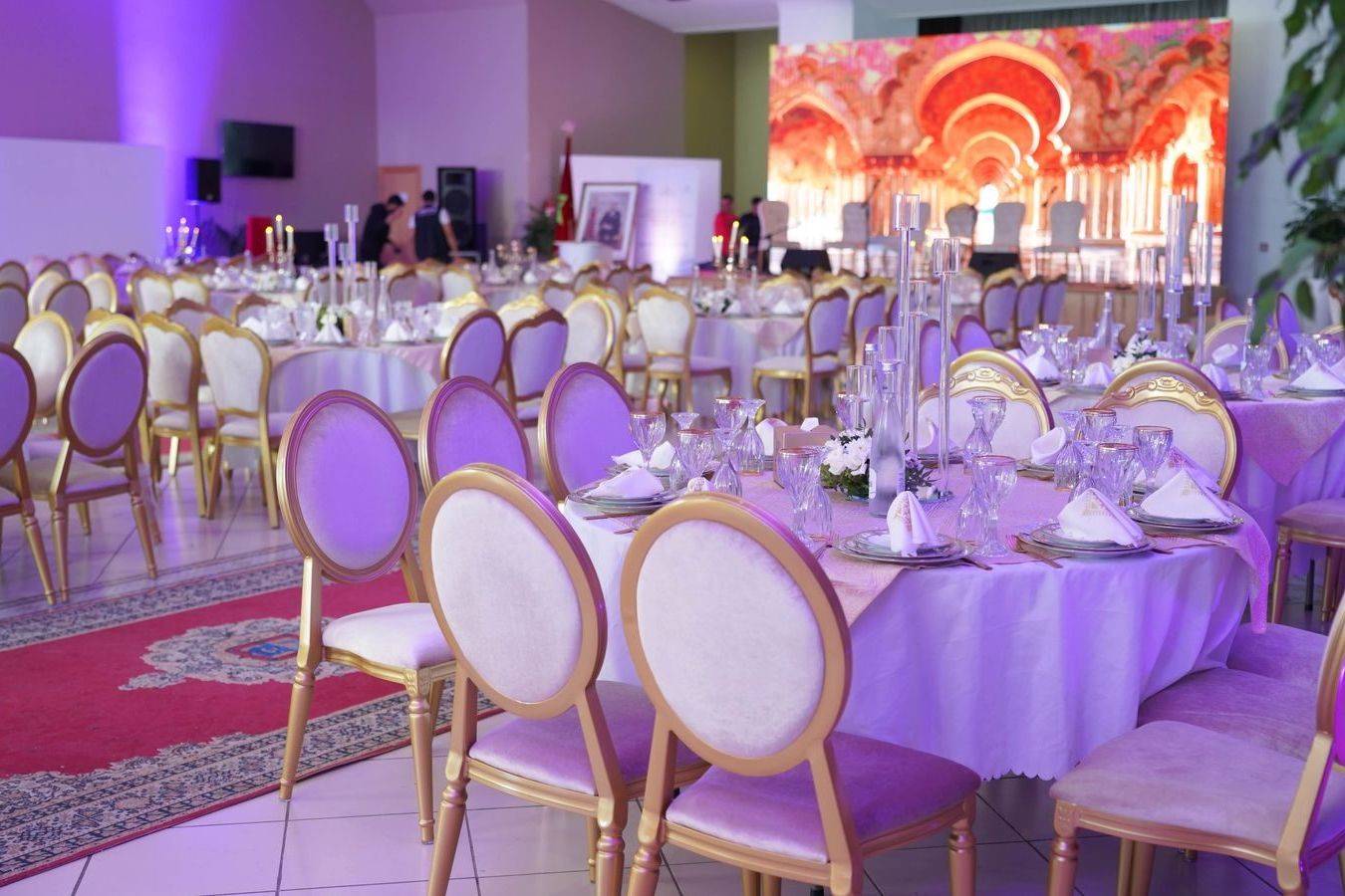 Round tables set for a gala dinner in a large ballroom