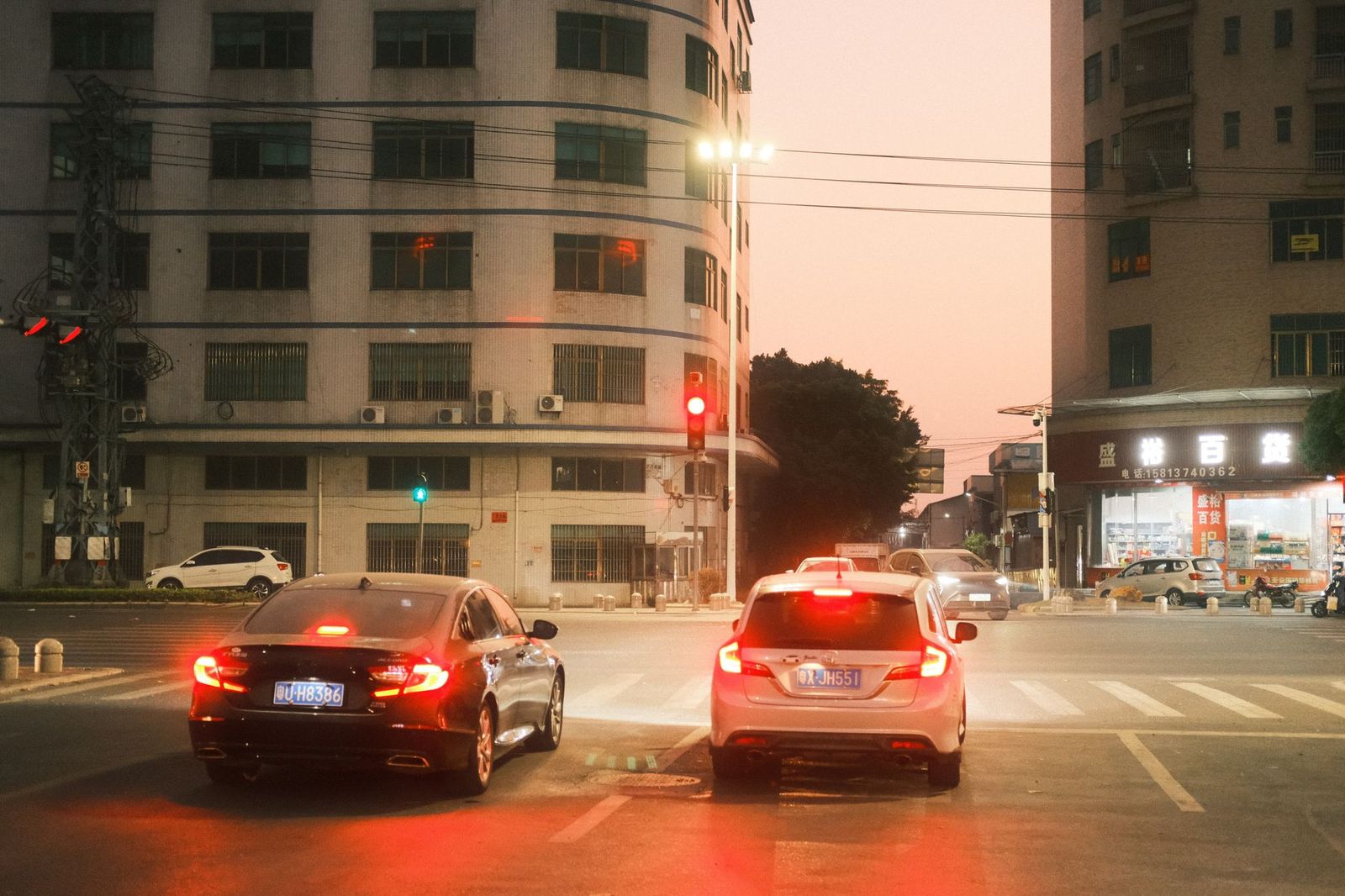 A black car on a Toronto street at dusk heading to a dinner reservation