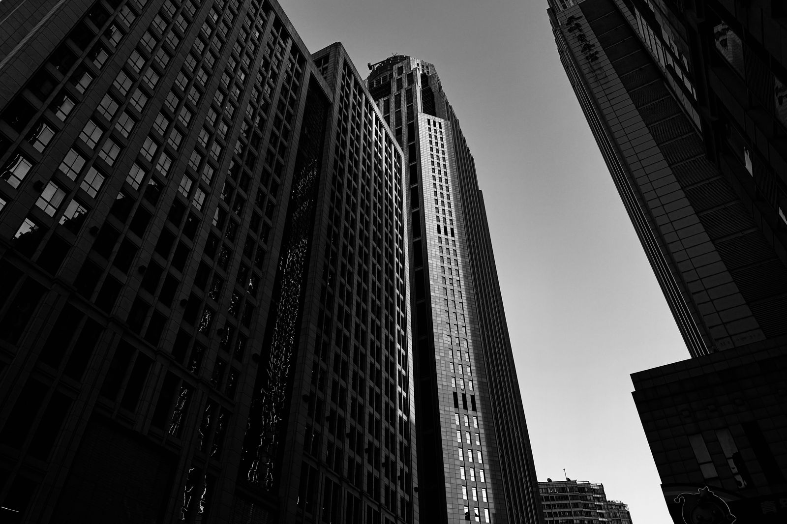 A black sedan outside downtown office towers
