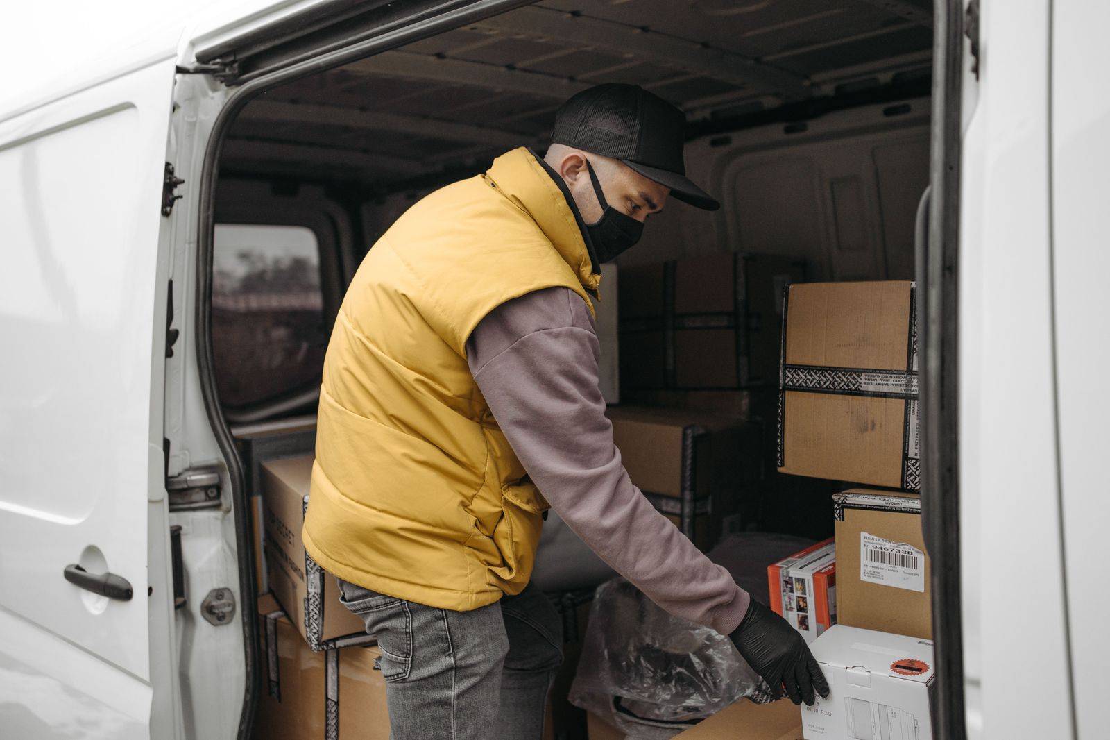 A chauffeur loading luggage into the trunk before the run from Cambridge to Pearson