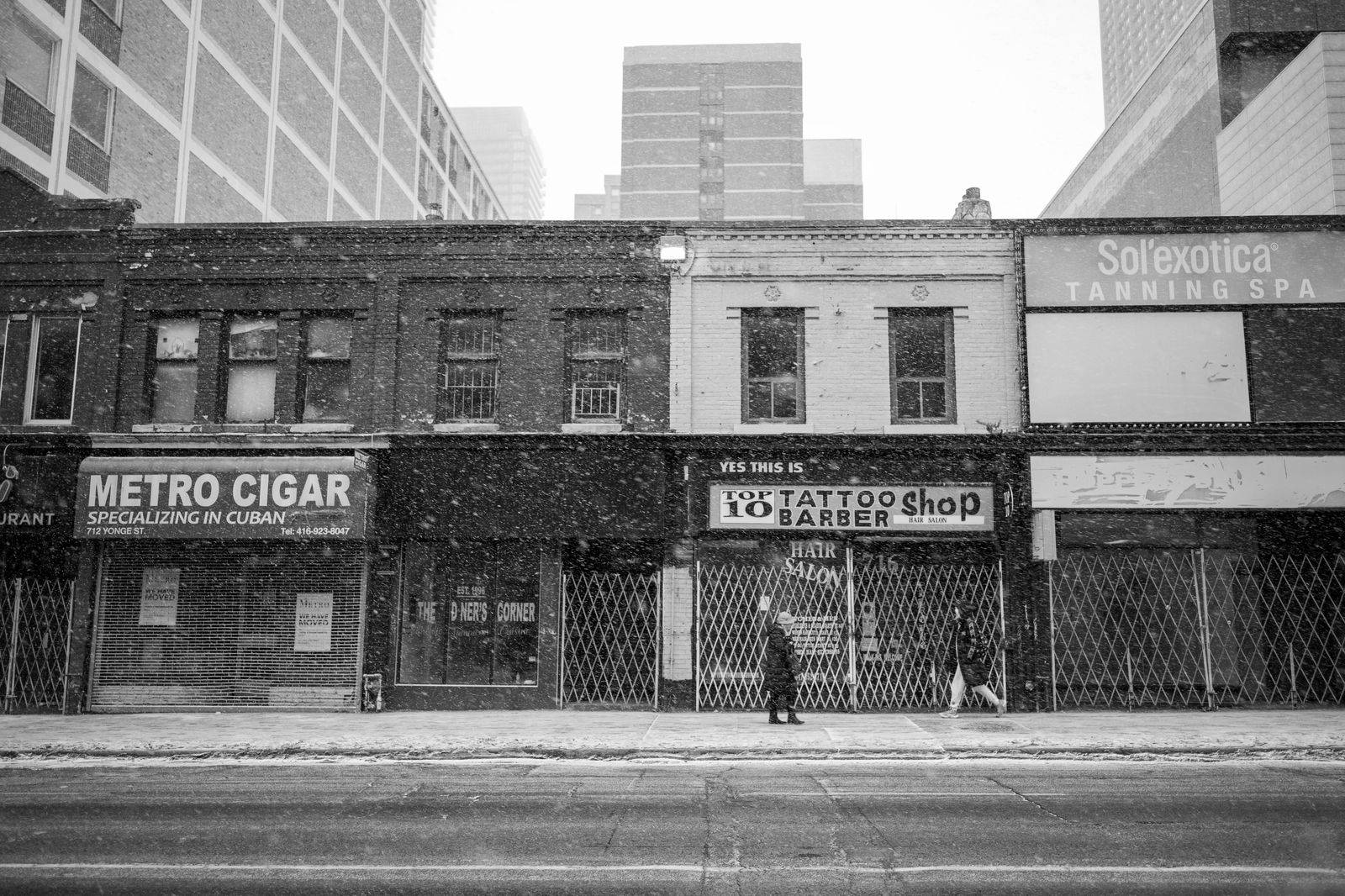 A busy downtown Toronto street with shops and traffic