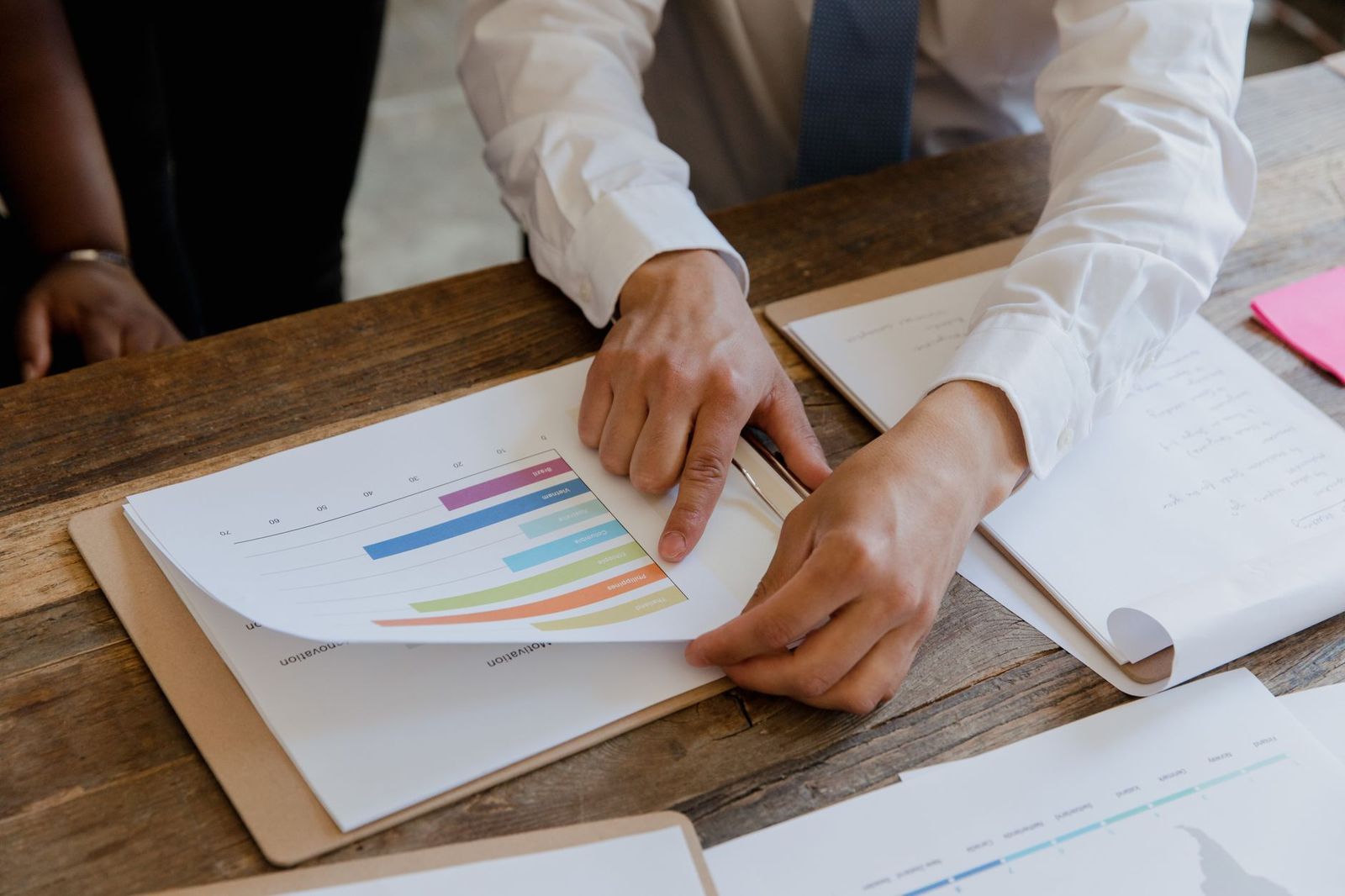 An invoice and spreadsheet on an office desk at month-end