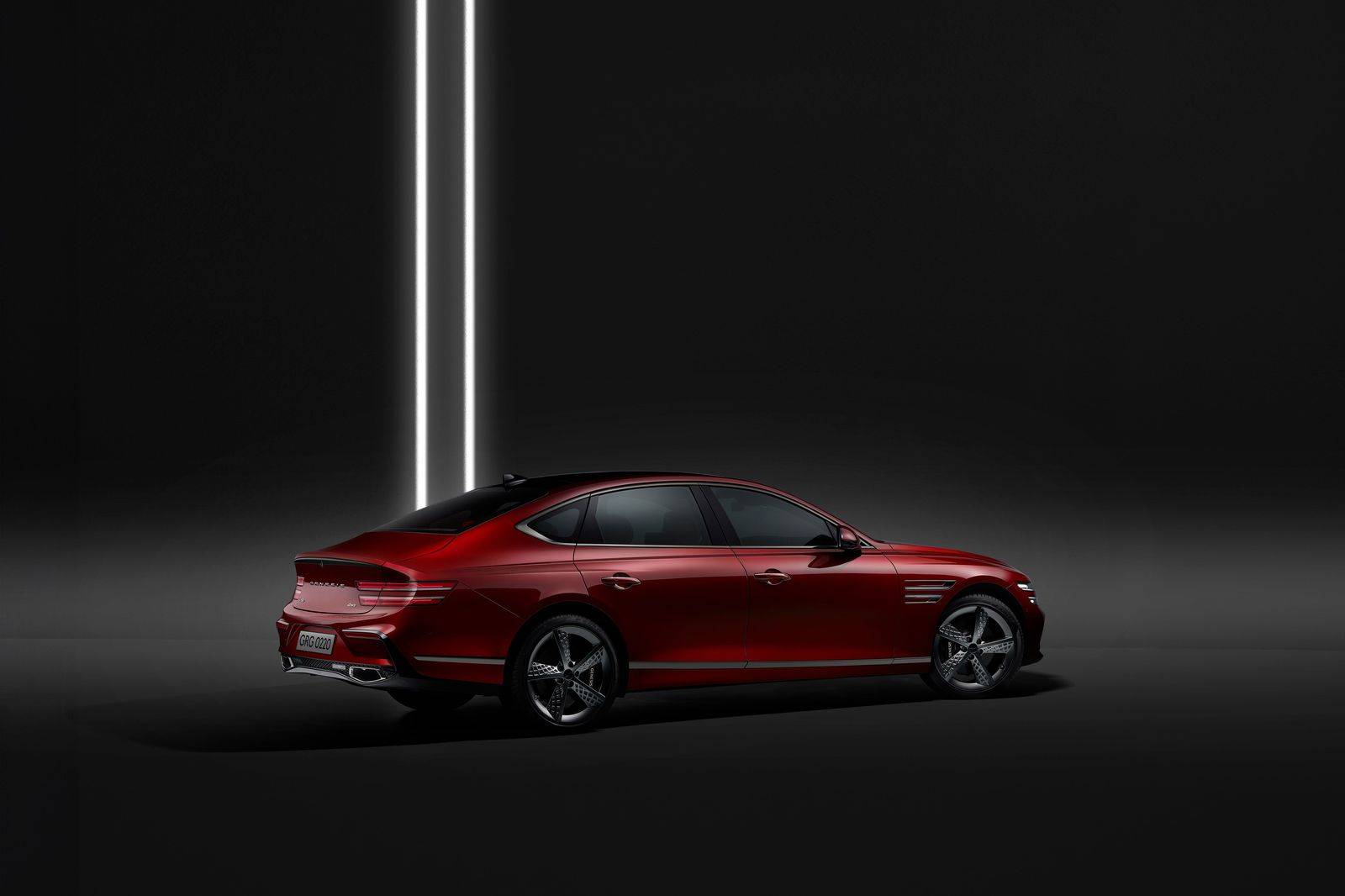 A black sedan with its rear door open at night, ready for the ride home