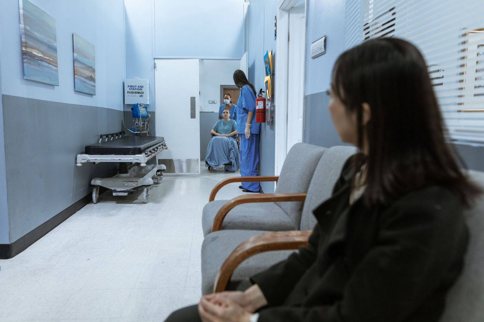 A quiet clinic waiting room with chairs and a reception desk