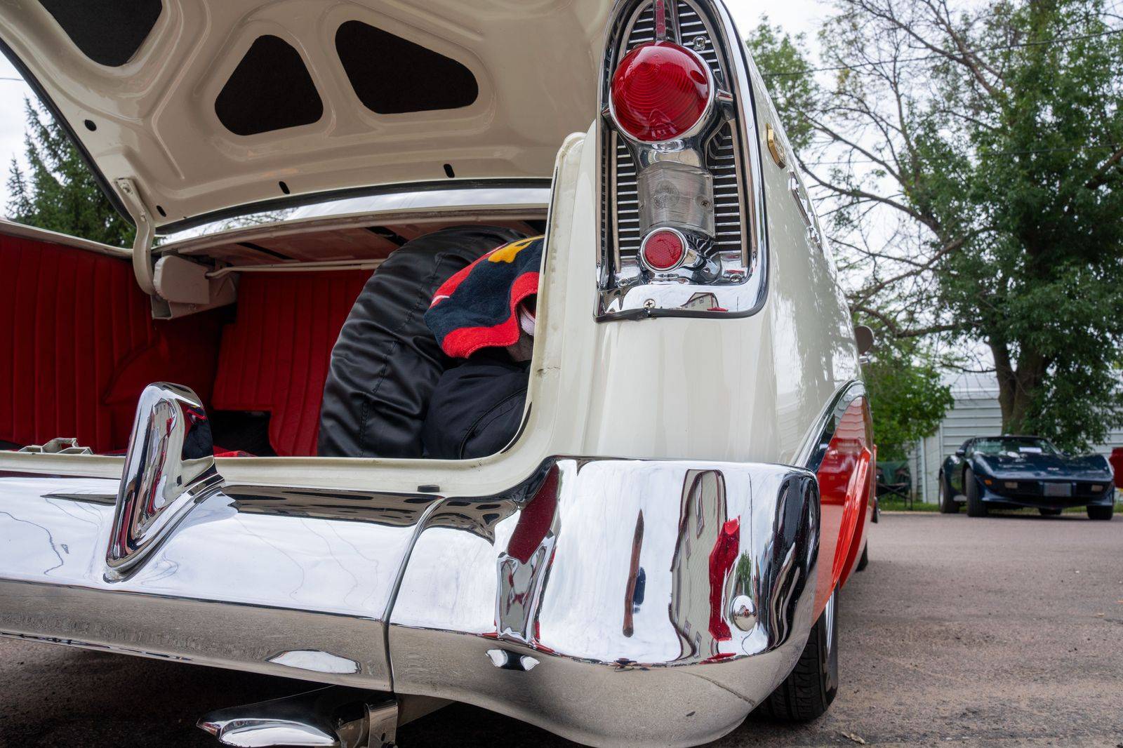 A folded walker placed in the open trunk of a car
