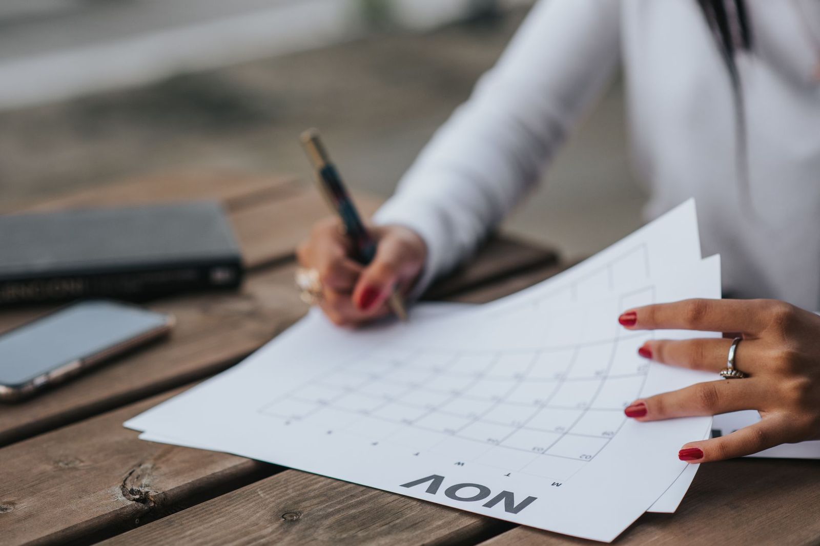 A notebook and calendar used to plan a funeral day and the family cars