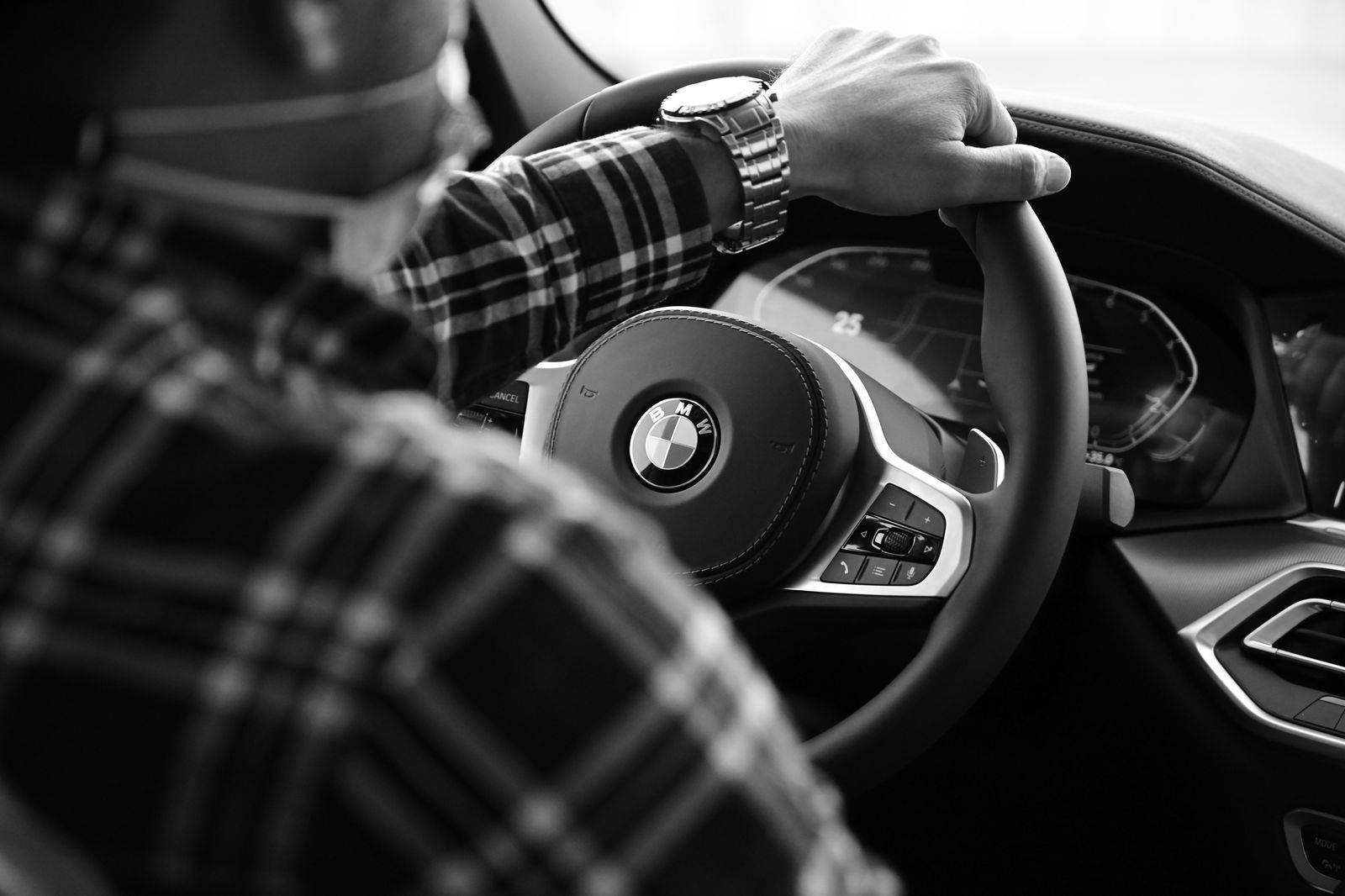 A chauffeur's hands on the wheel, timing an hourly booking in Toronto