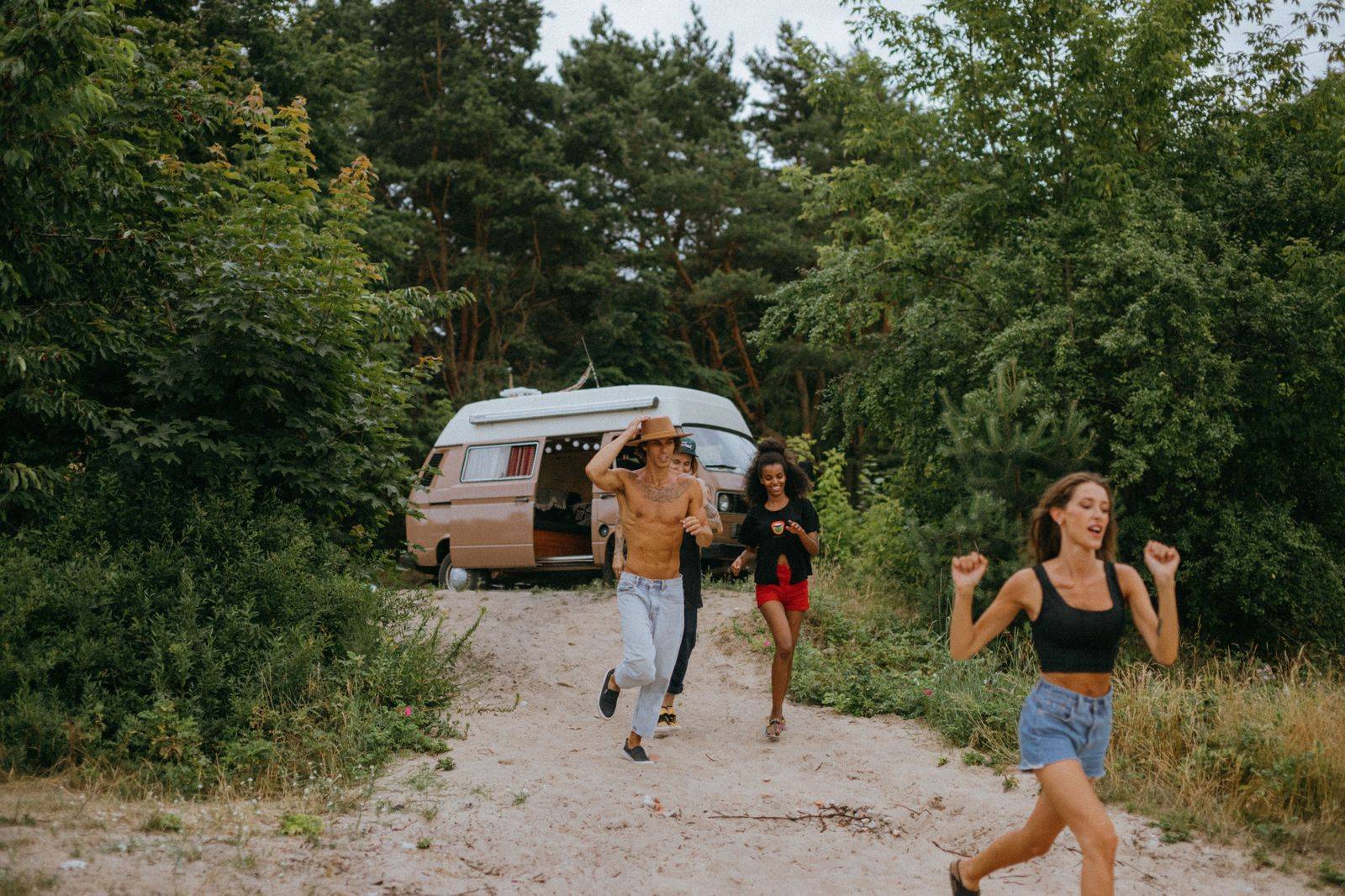 Group of friends travelling together in a van on a road trip