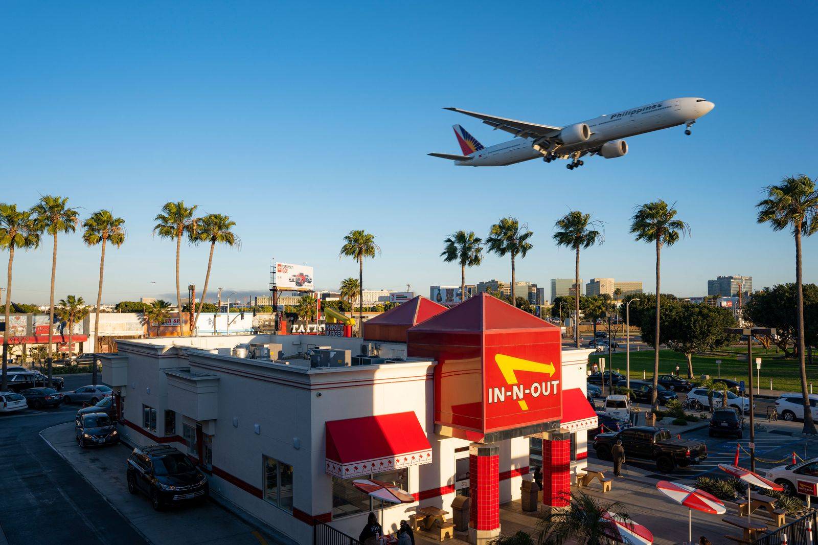 An airliner climbing out over a busy highway