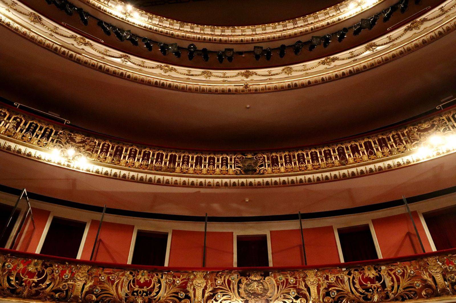 Audience applauding from the balconies of a historic concert hall