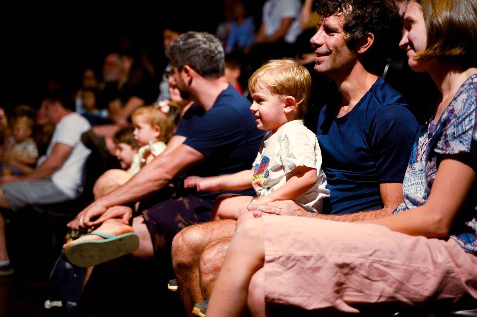 A family arriving at a downtown theatre for a weekend matinee