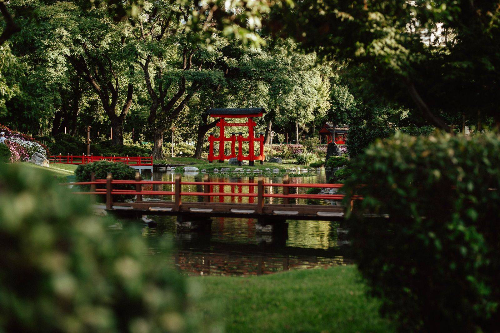 A footbridge over a pond in a Japanese-style garden