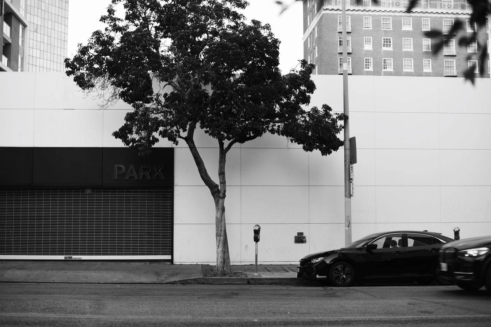 A black car parked on a downtown Toronto street between stops