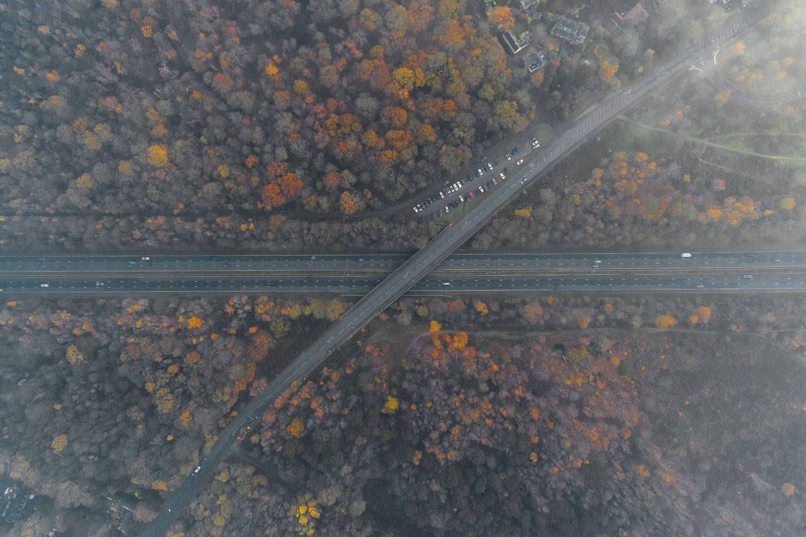 Highway traffic between forested hills on the drive south from Muskoka