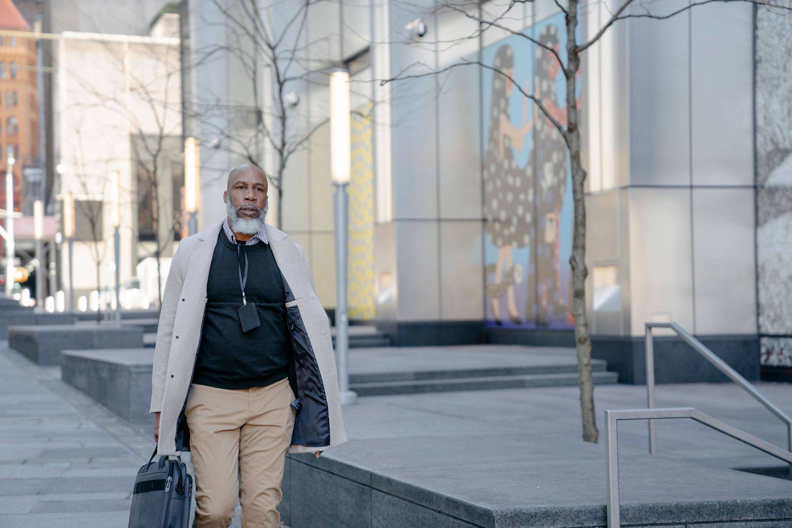 A business traveller with a carry-on walking quickly through an airport terminal