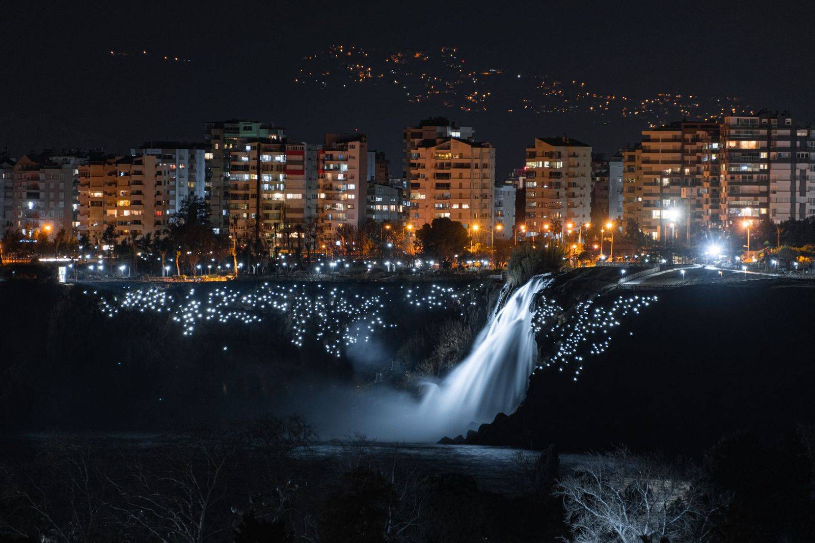The falls lit in colour after dark, seen from the Canadian side