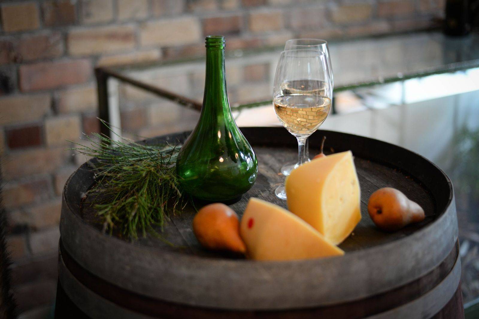 A row of tasting glasses on a bar in a winery barrel room