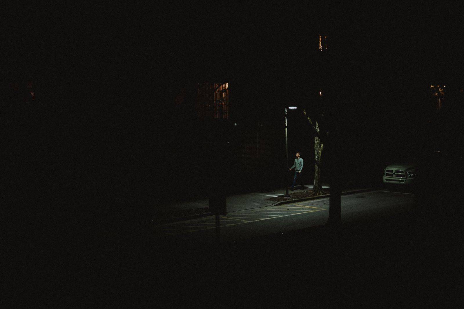 A black SUV waiting on a downtown Toronto side street late at night