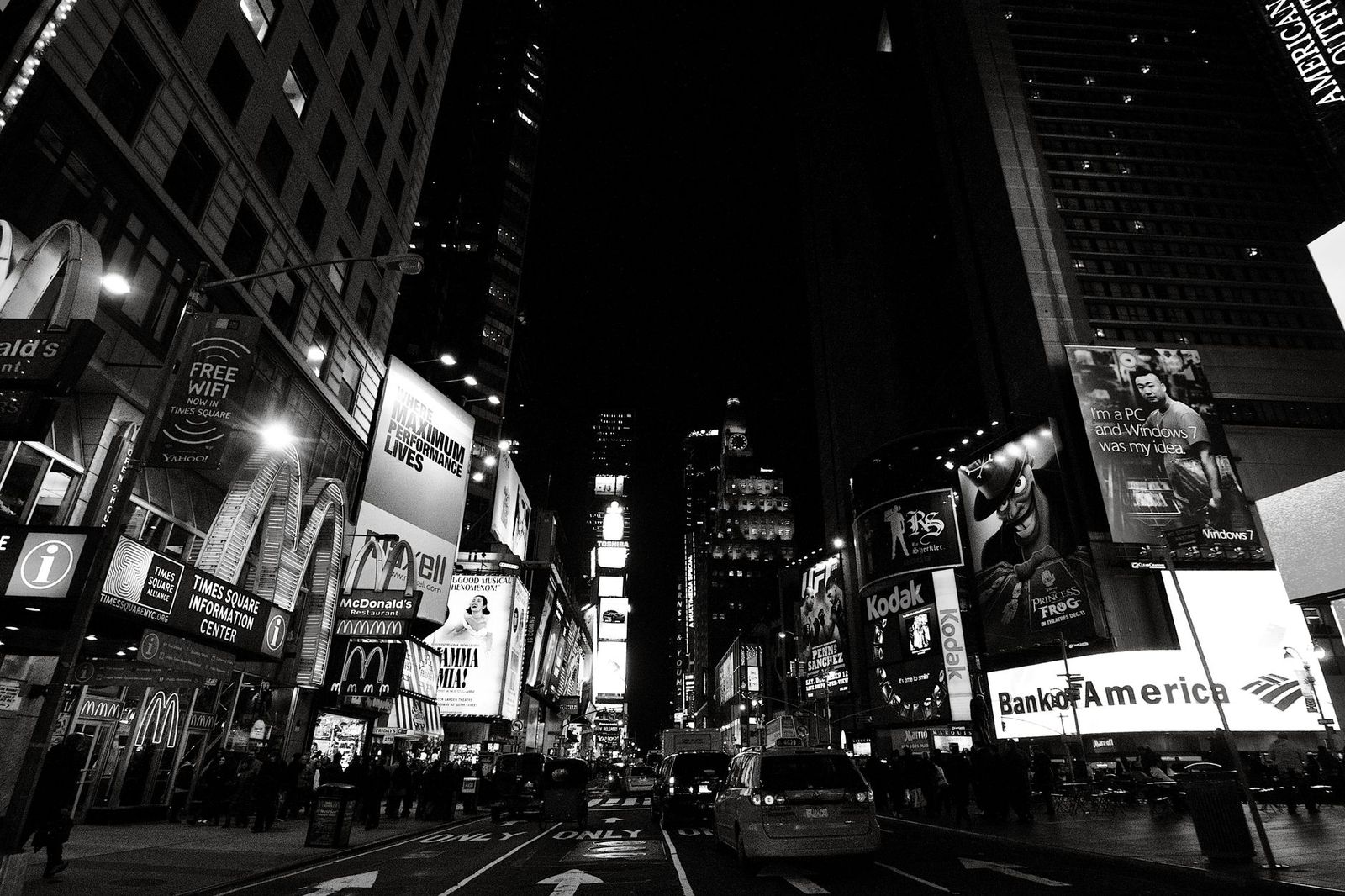 A black sedan on a New York street at night outside a Midtown hotel