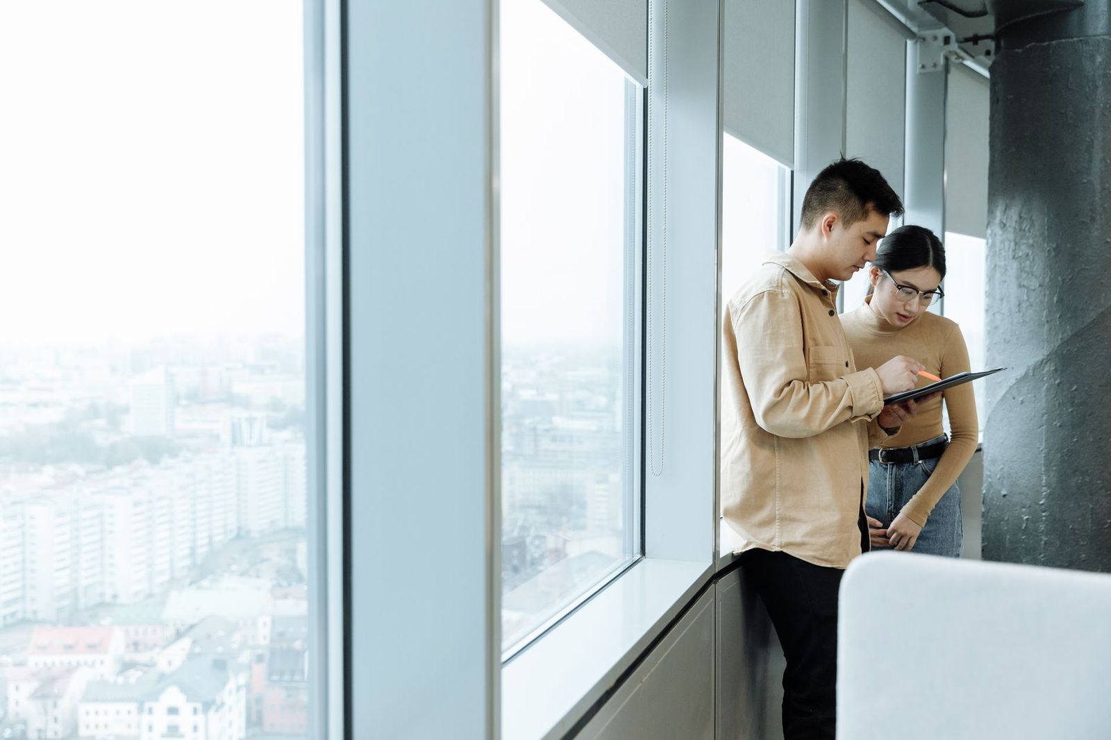 A business meeting room with a window view over a city skyline