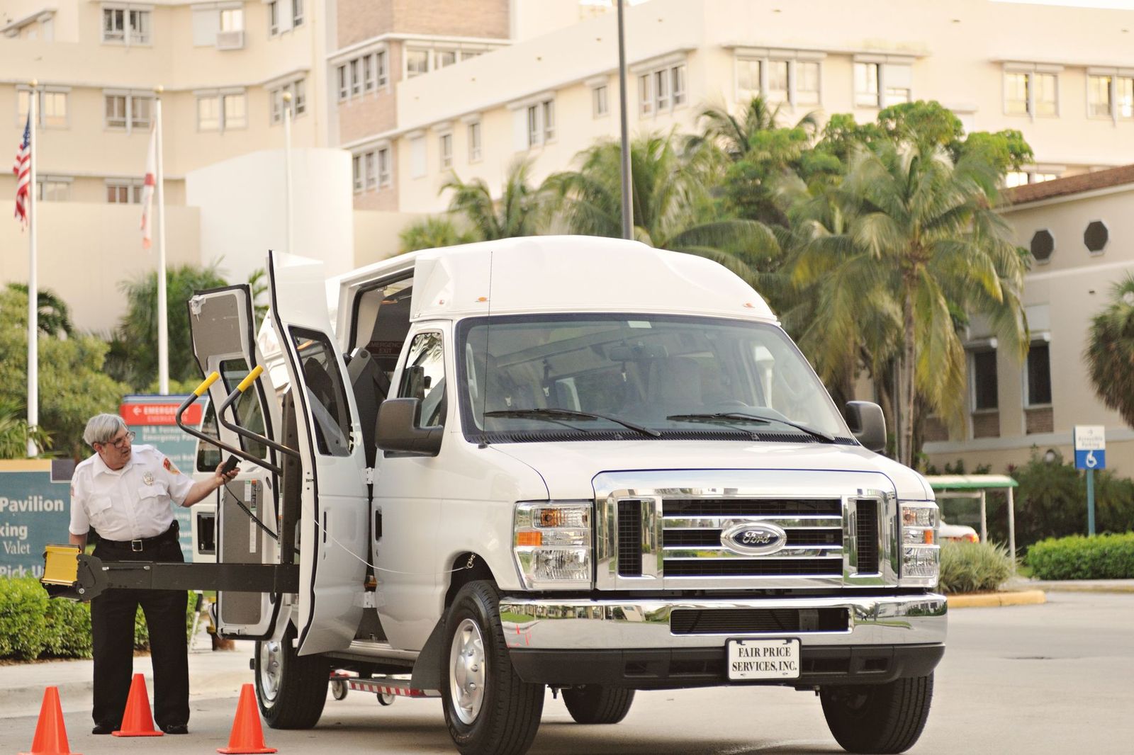A passenger van parked at a hotel entrance ready to take guests to a wedding reception