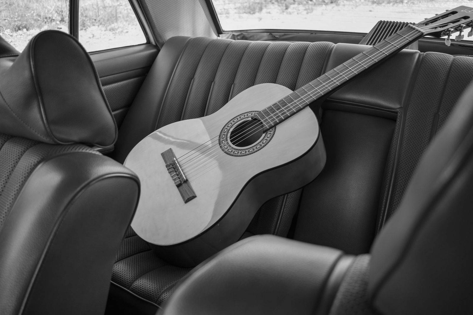 The leather rear seat of a chauffeured car, ready for the drive from Pearson back to Peterborough