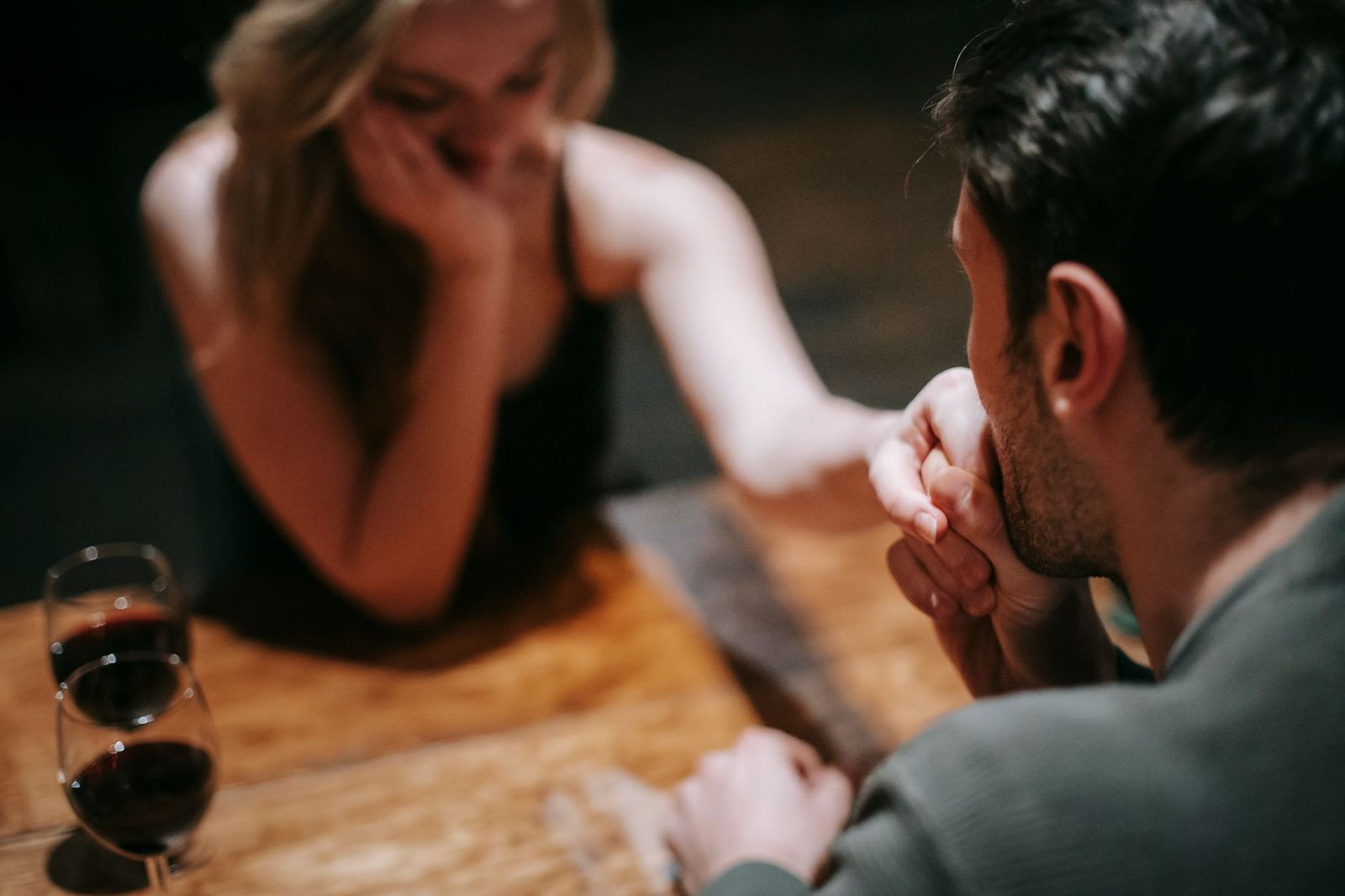 A couple at a candlelit restaurant table before a show on King Street West