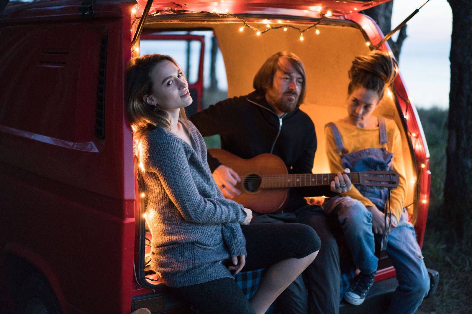 A group of friends climbing into a van to celebrate a festival weekend