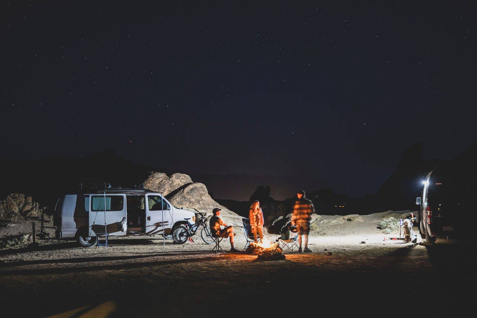 Friends climbing into a black van after a summer concert