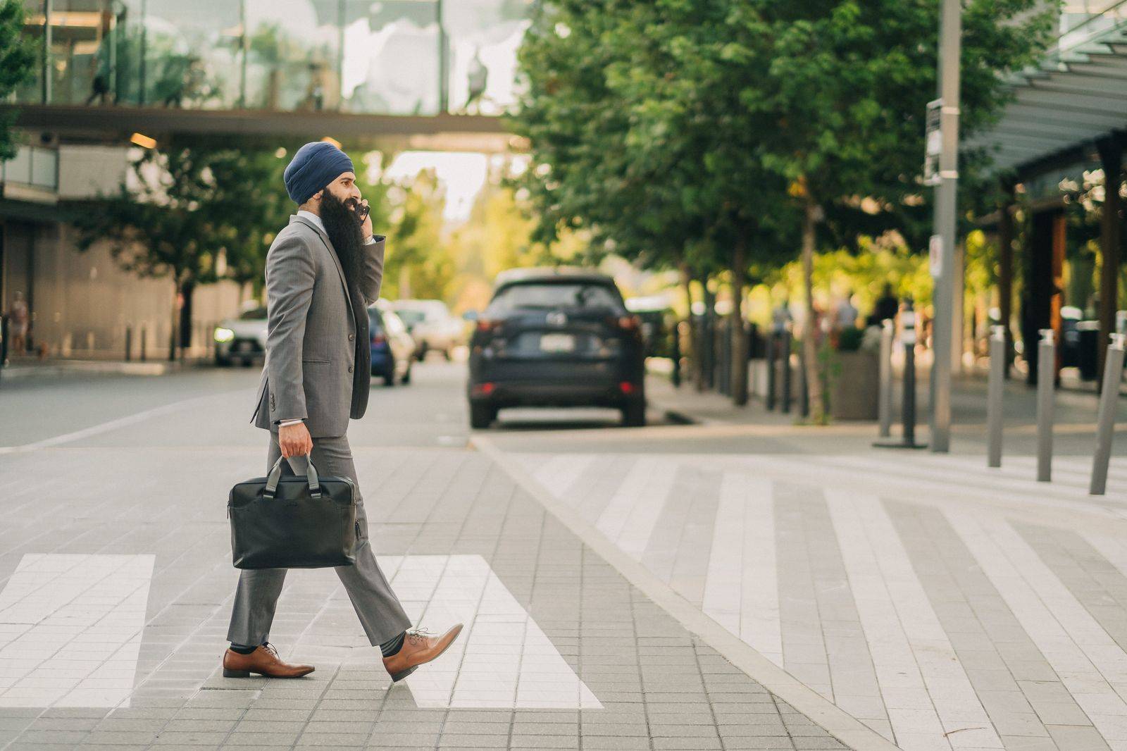 A businessman with a briefcase stepping into the back of a car