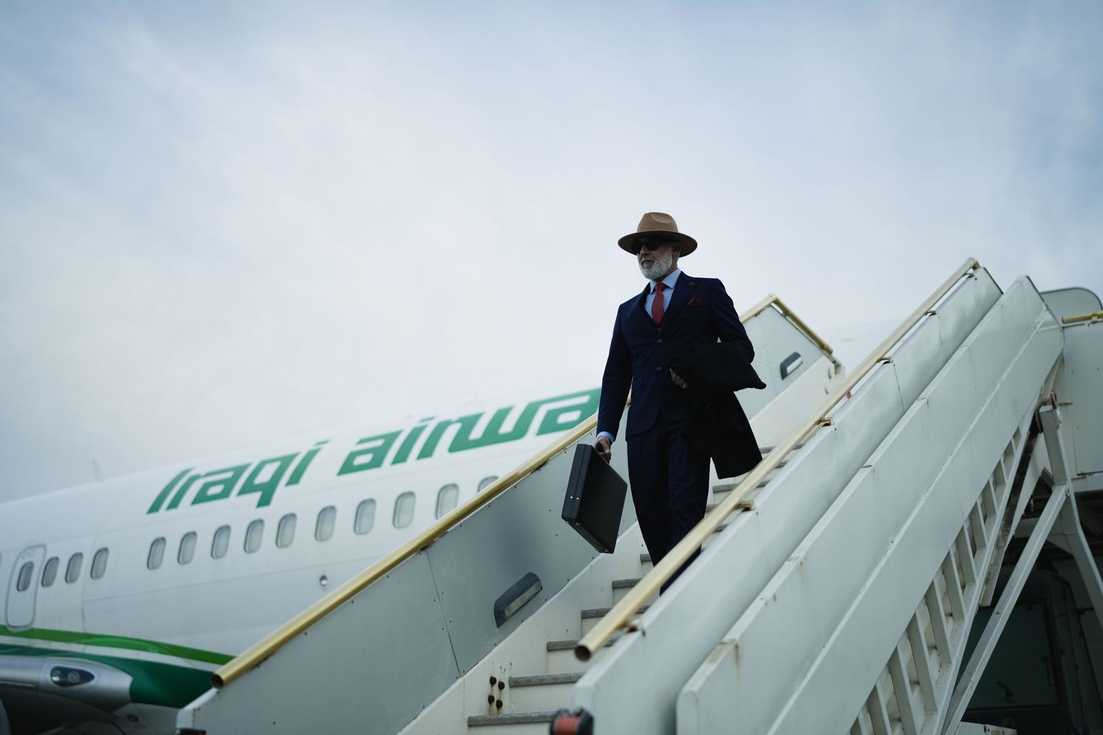 An executive walking from a private aircraft to a black SUV at Pearson