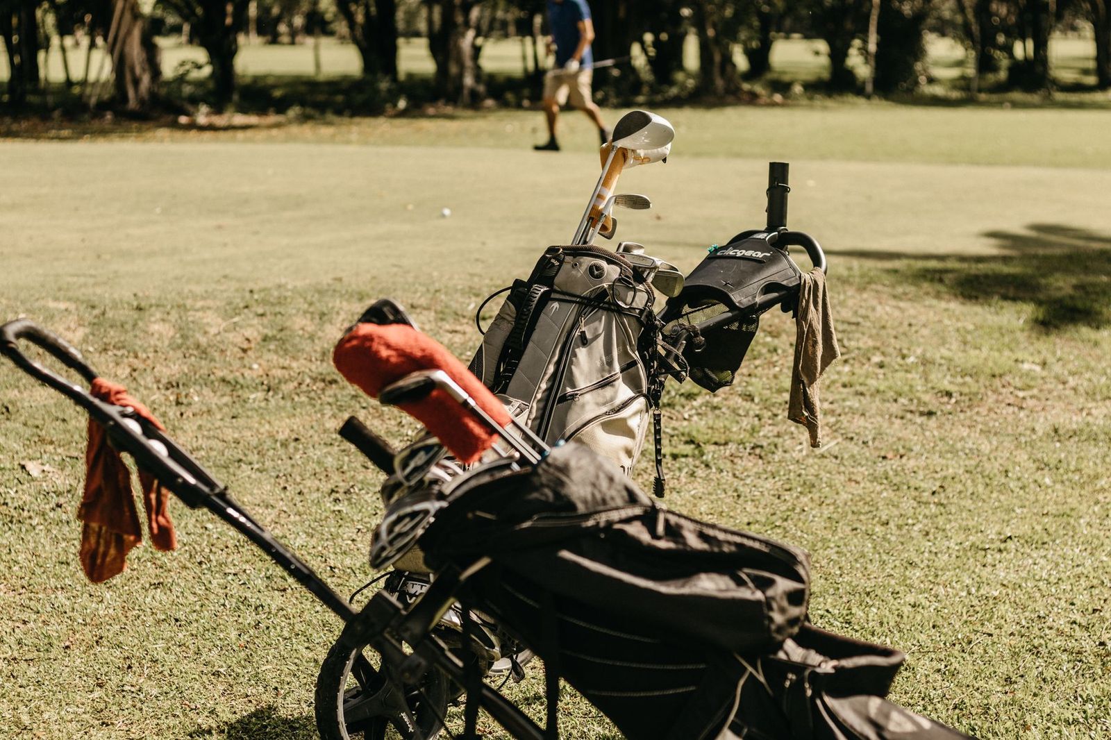 Golf bags stacked in the back of a vehicle before a group golf day