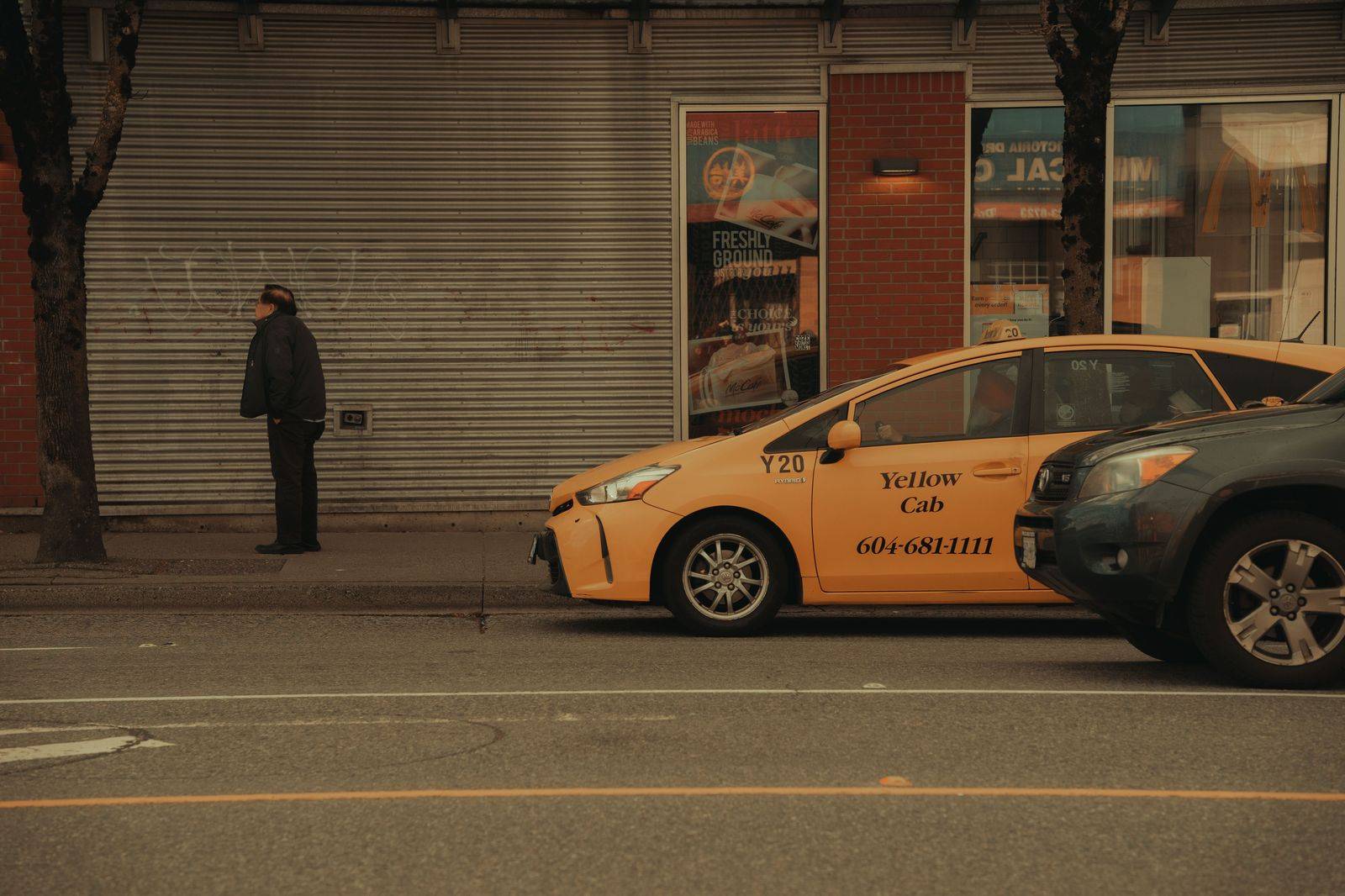 Black sedan waiting on a quiet downtown street near Toronto's hospital row