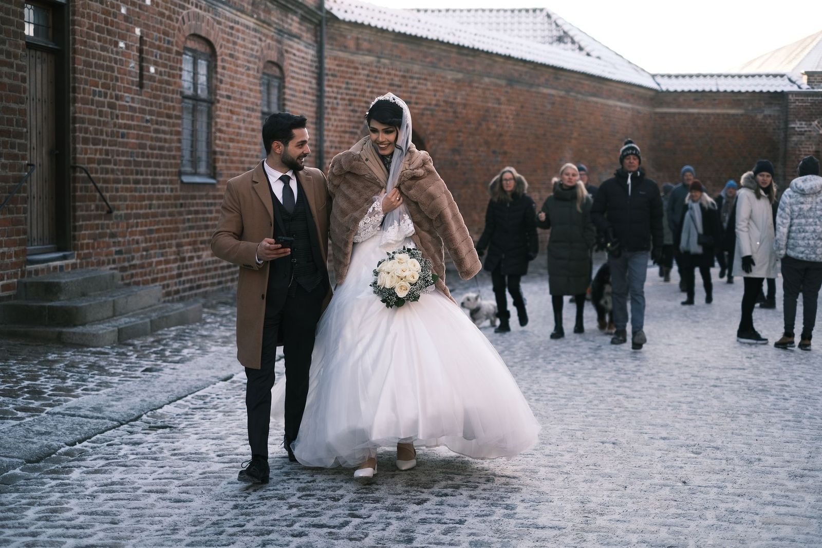 A bride walks through a brick courtyard to a Toronto ceremony after the car sets down nearby