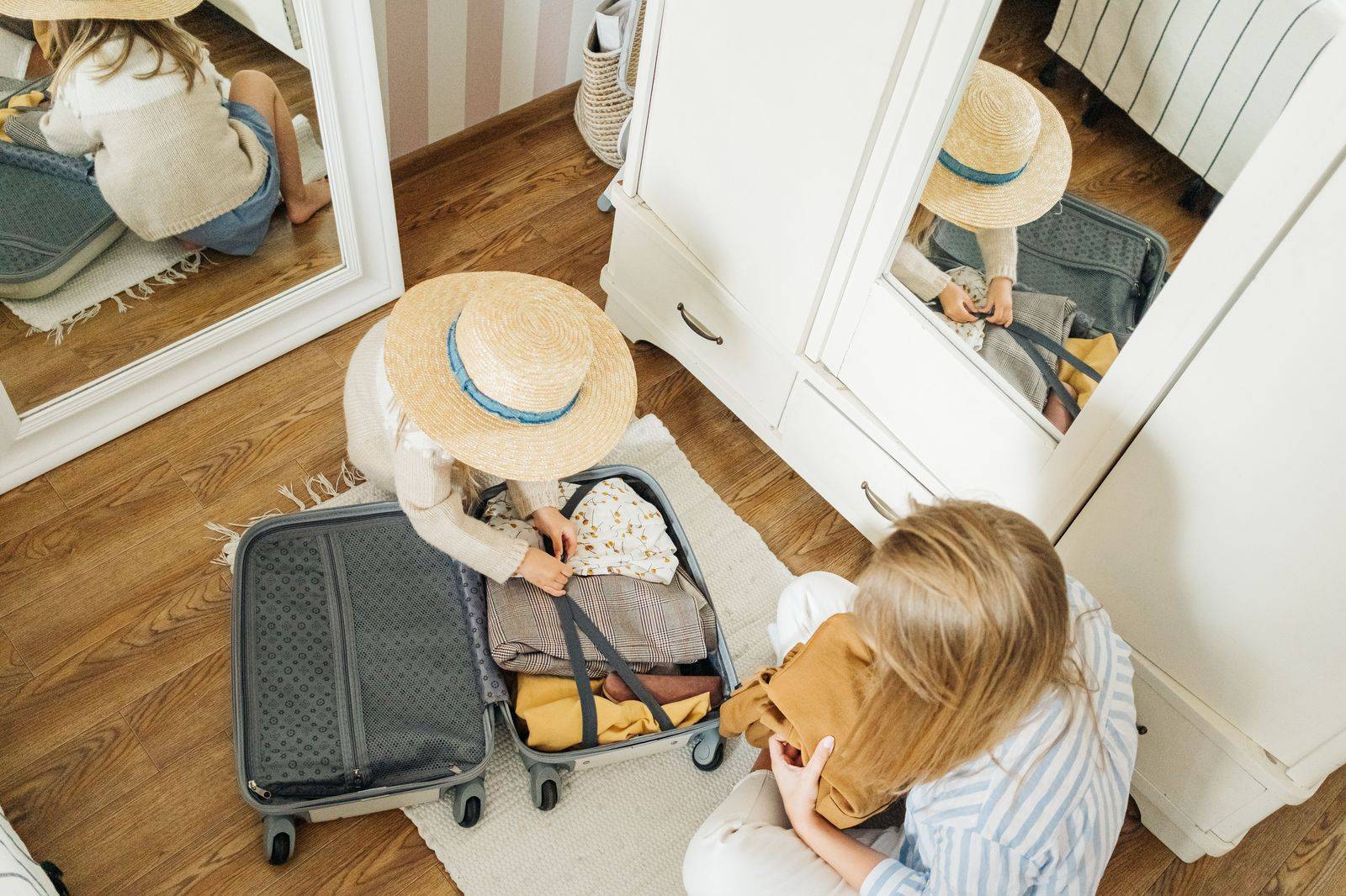 A family with suitcases at an airport curb ready for a holiday flight