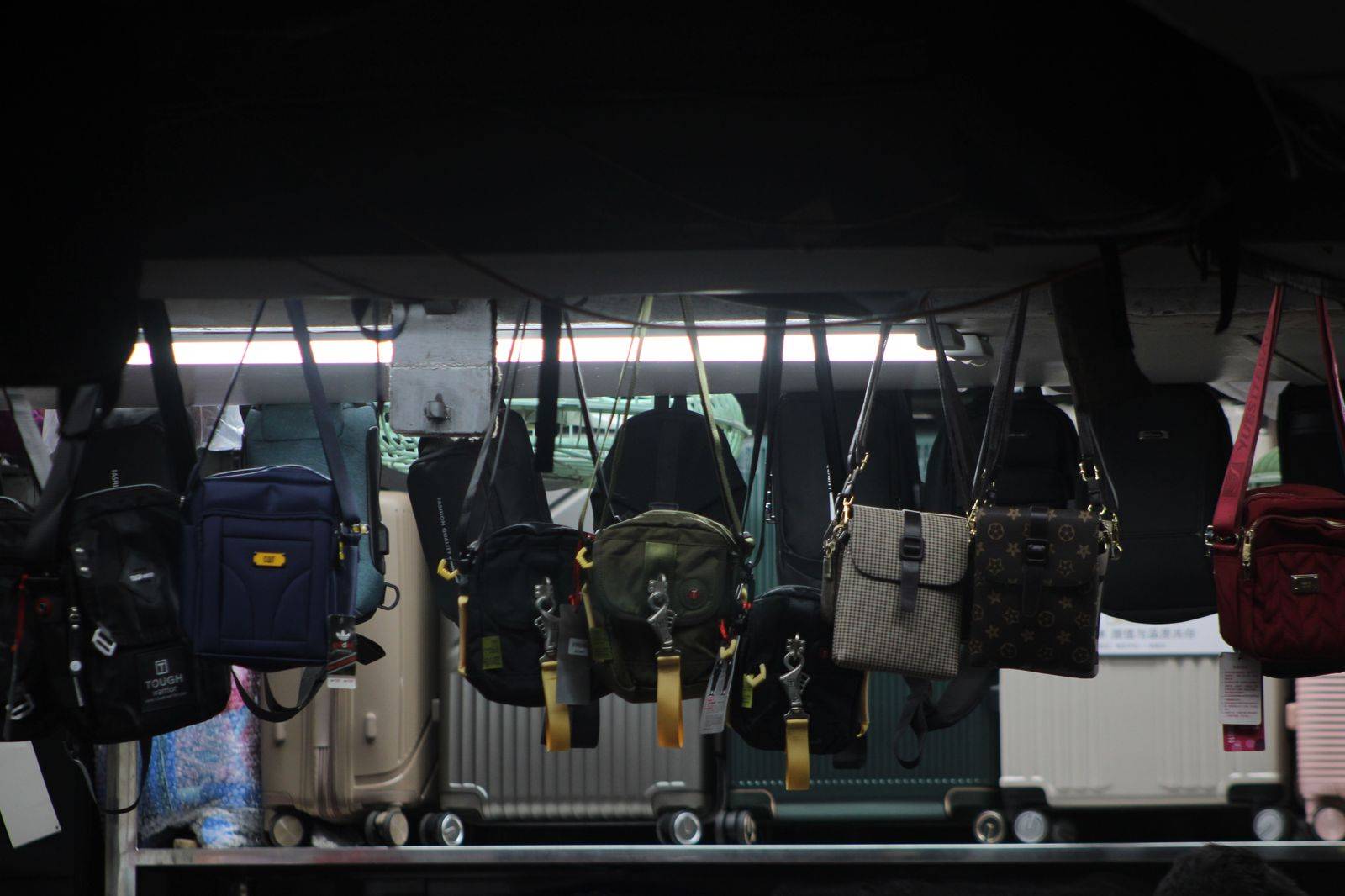 Suitcases arriving on an airport baggage carousel after an international flight
