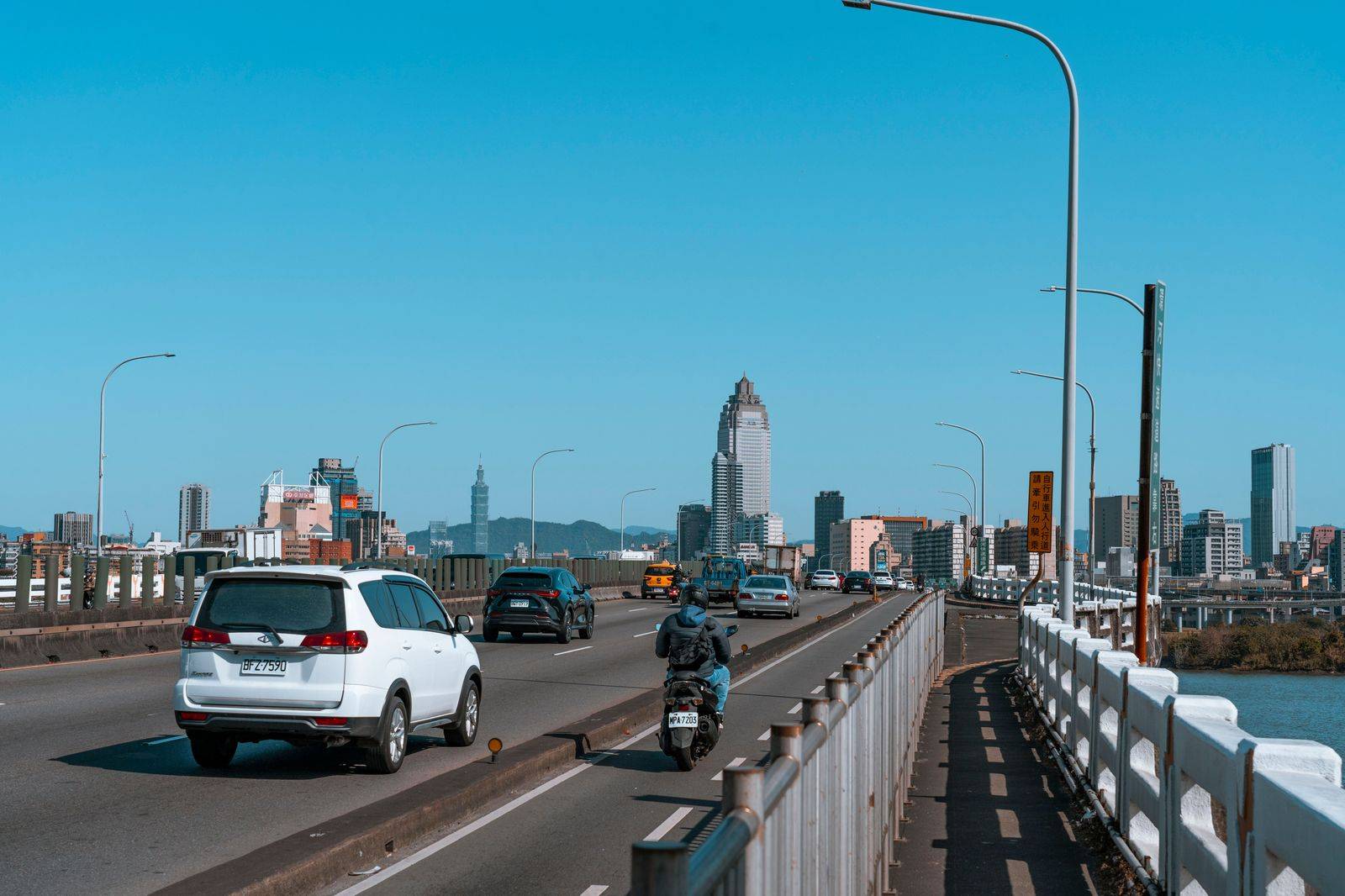 Cars moving along an airport access road outside the terminals