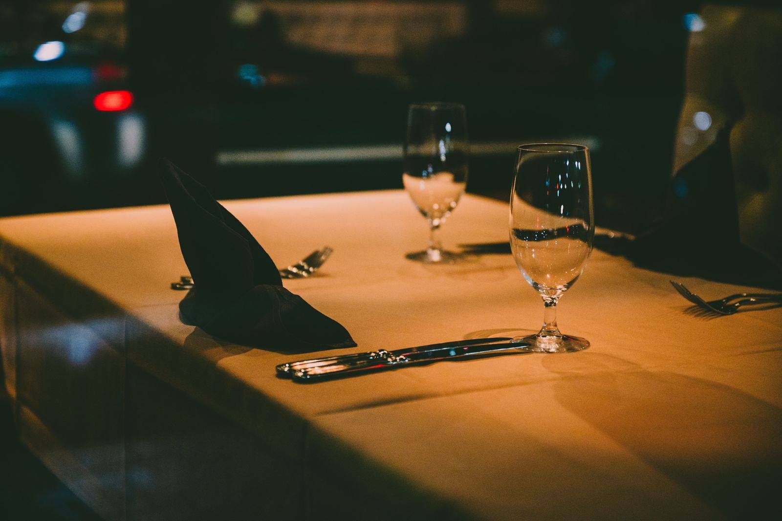 A dinner table by a window at night above the illuminated Falls