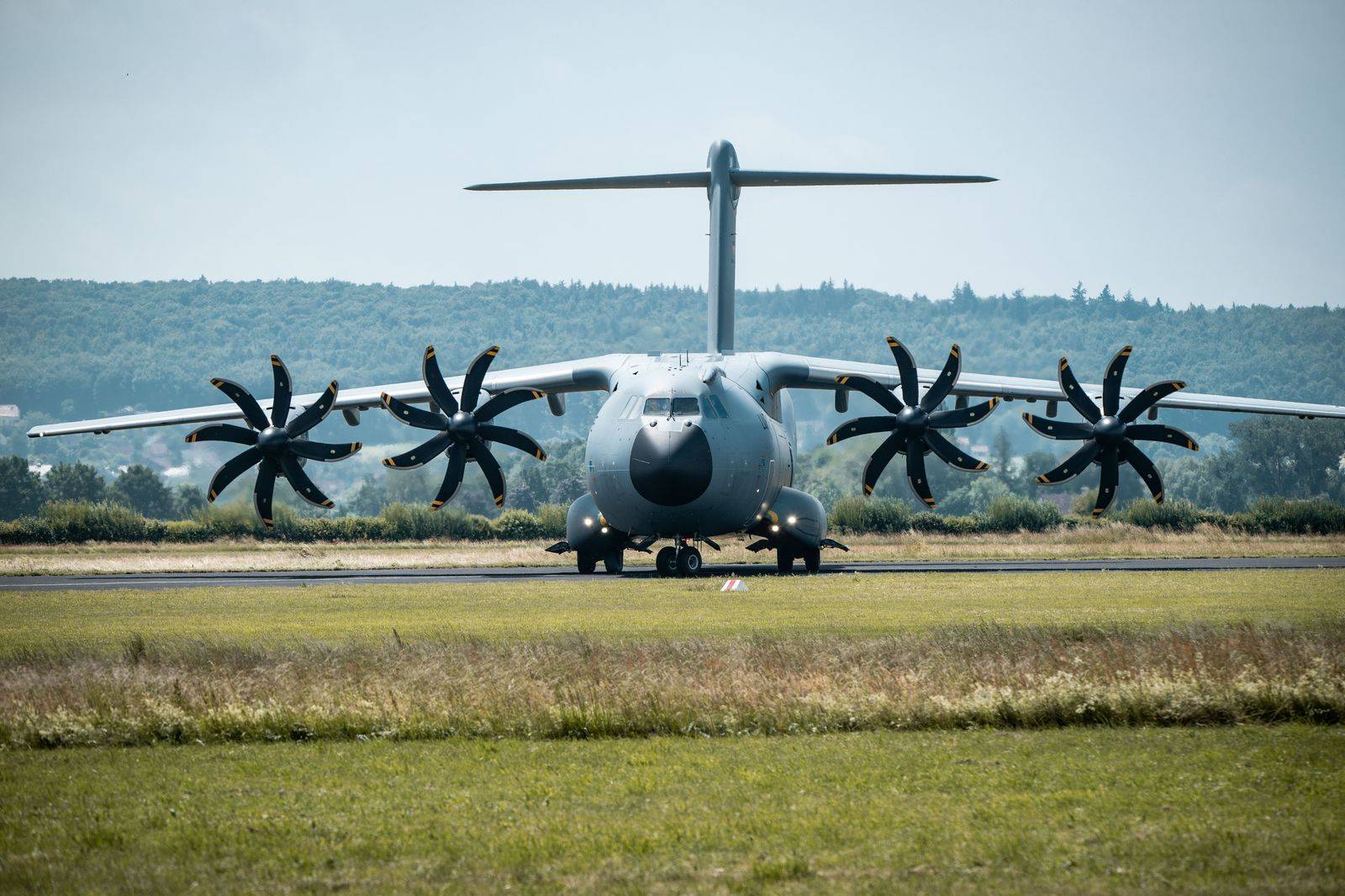 A military transport aircraft on a runway, a reminder of the travel tied to 8 Wing Trenton in Quinte West