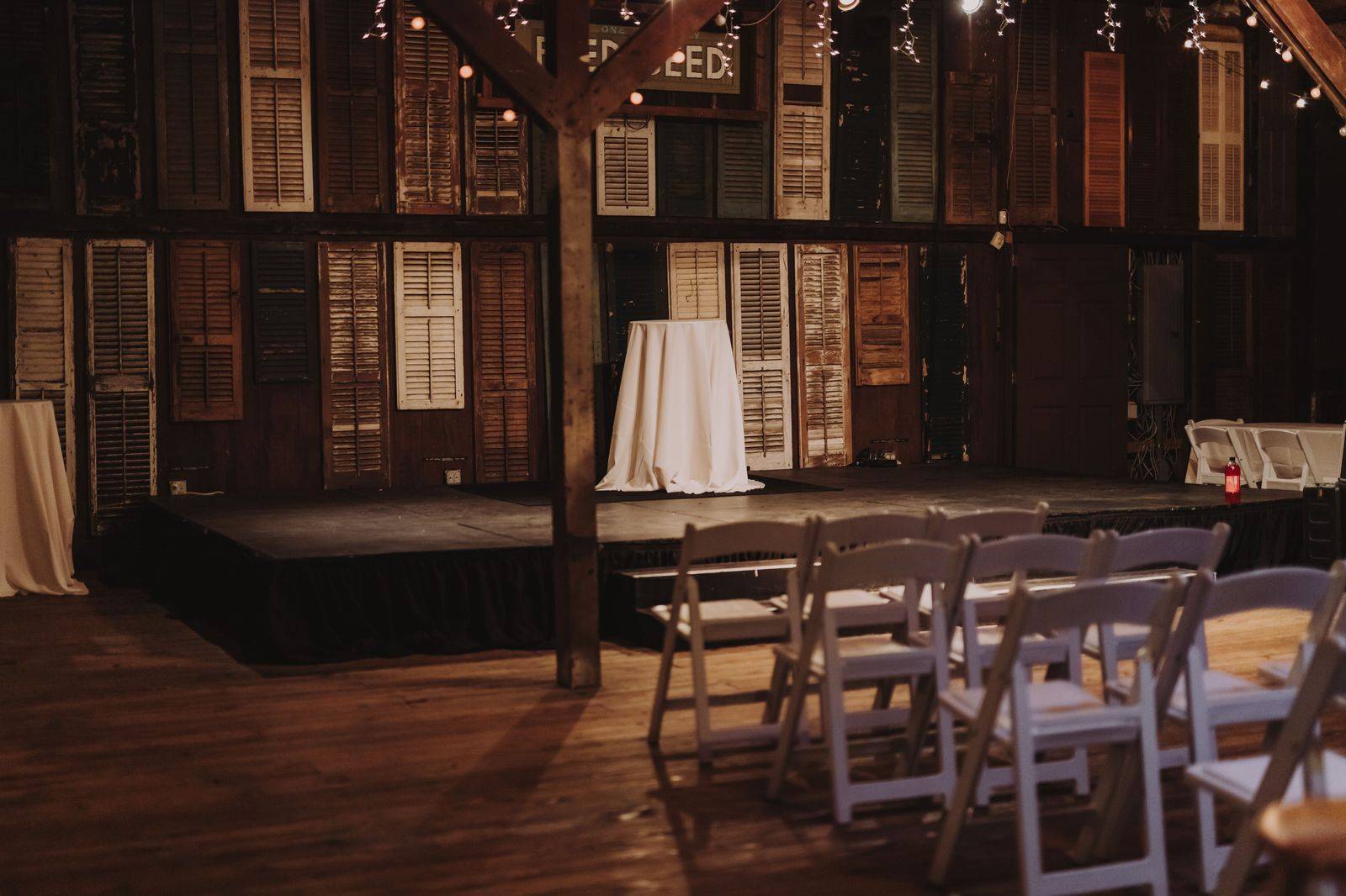 A rustic barn wedding venue lit up in the evening